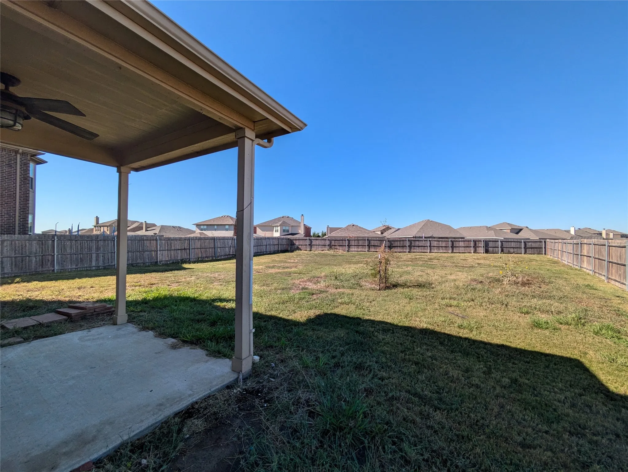View of yard with ceiling fan and a patio area