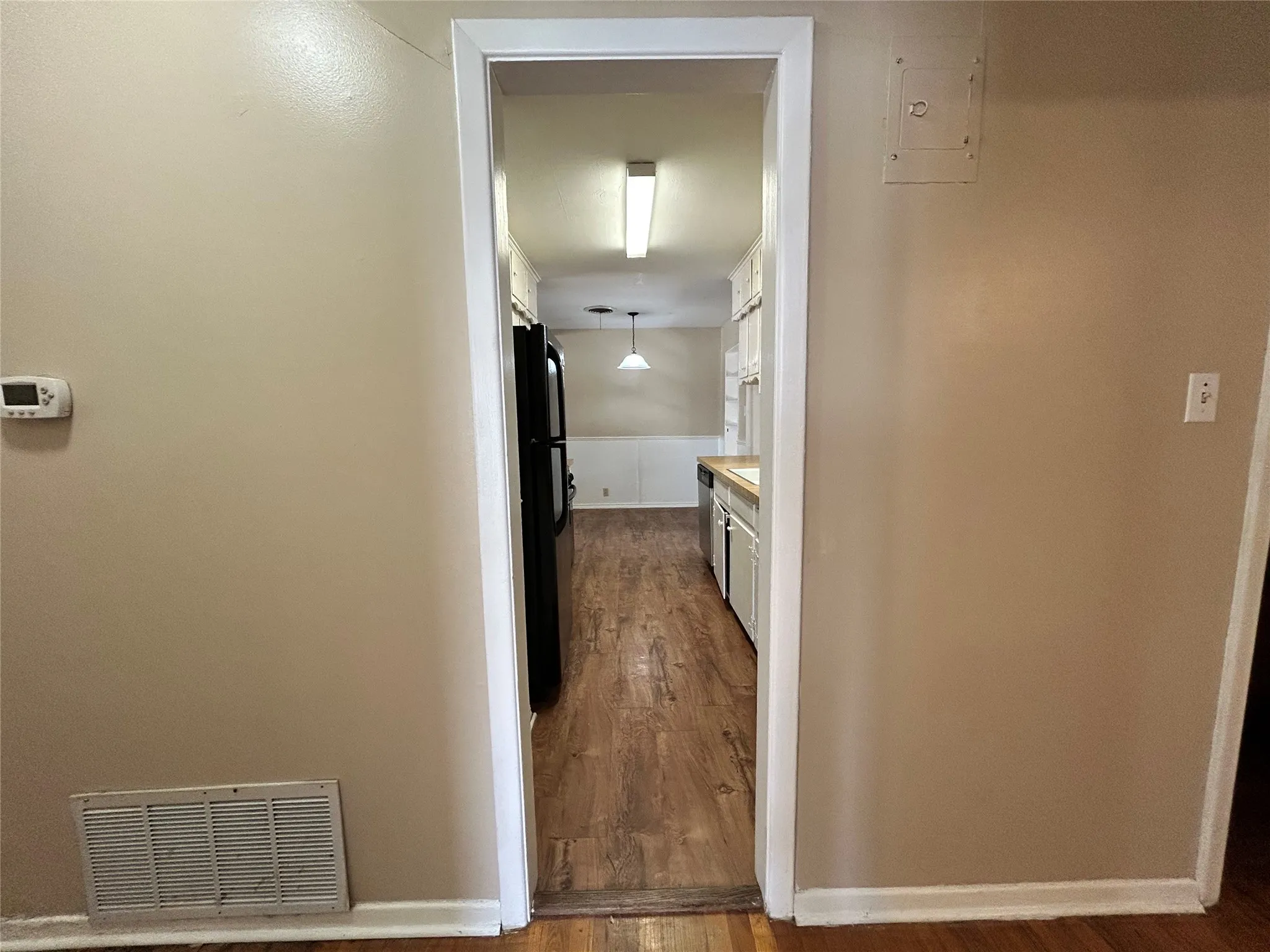 Wood-finish flooring throughout, white trim, and light wall tones