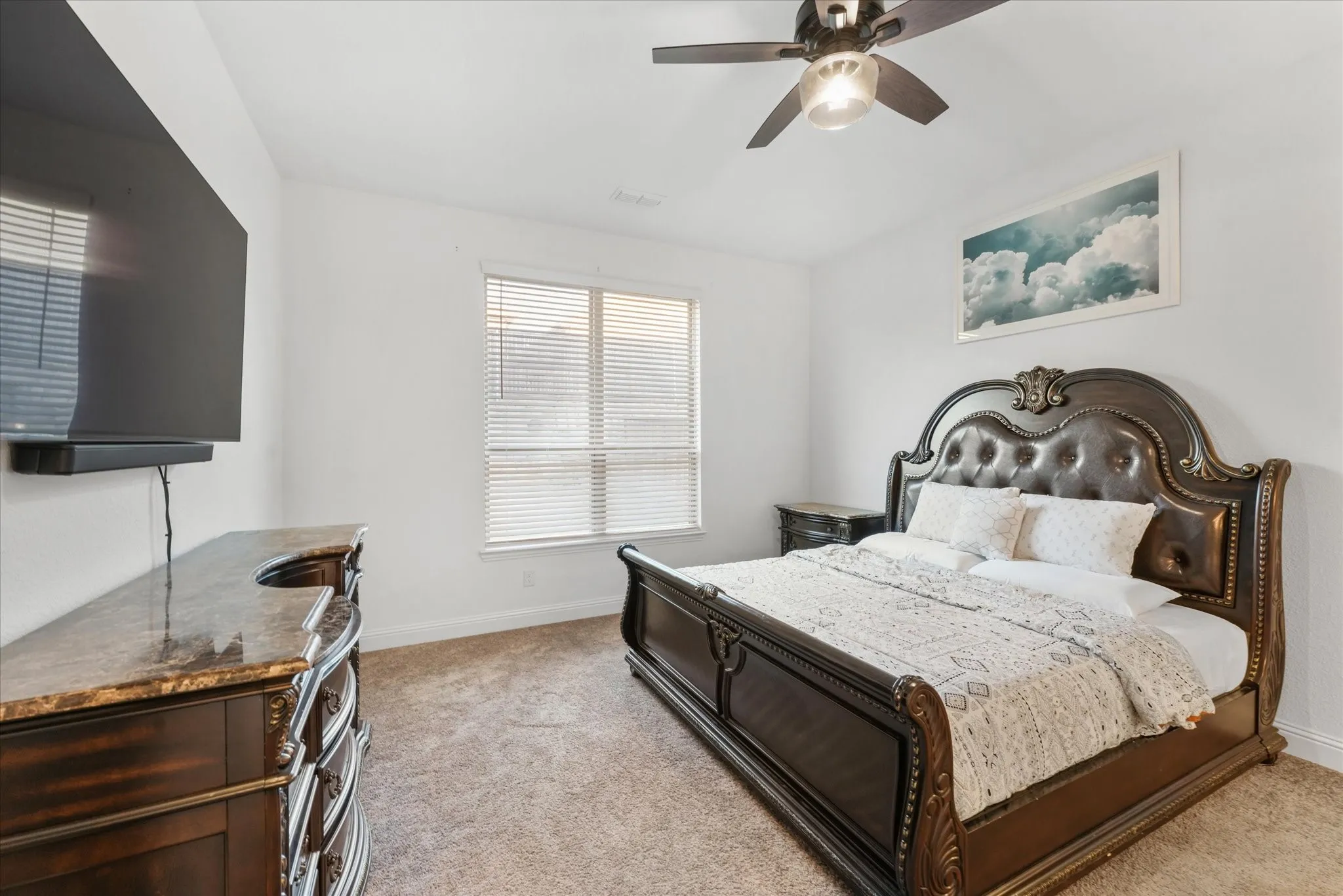 Carpeted room featuring a ceiling fan with integrated lighting, a window with horizontal blinds, and white walls
