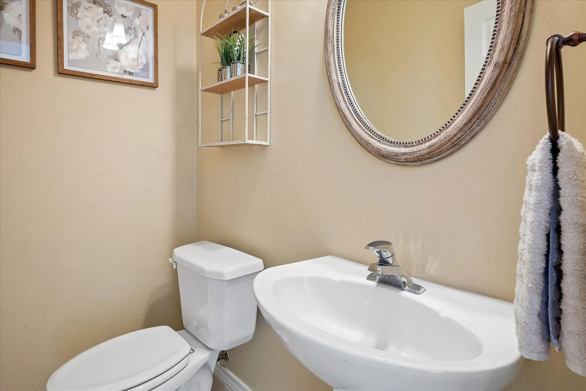 Half bathroom is conveniently tucked beside the stairs on the first floor for guests.