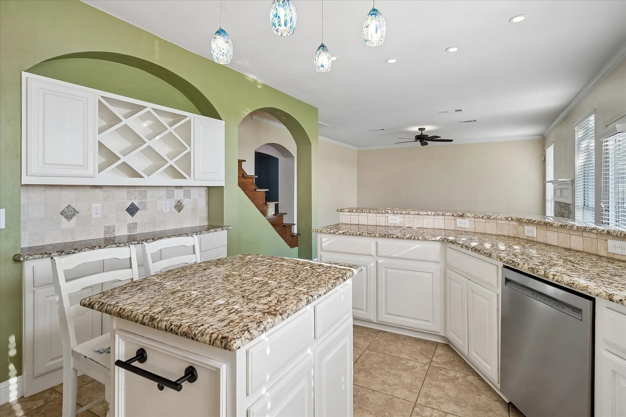 Built-in Dry bar with wine rack, decorative backsplash, drawers, and cabinets gives you plenty of storage for everyday living or entertaining.