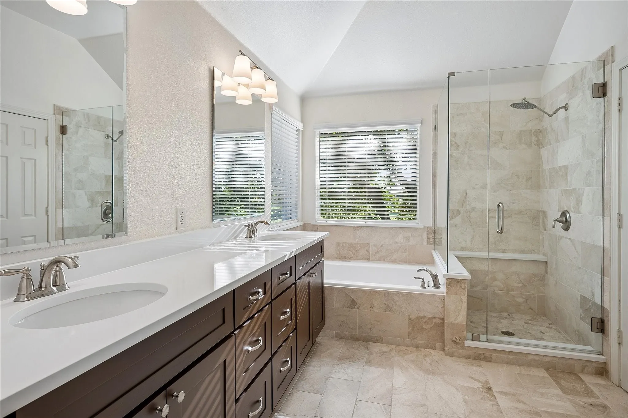 Spa-inspired bath, updated in Dec 2025, with Quartz counters and marble from the floor to the shower!