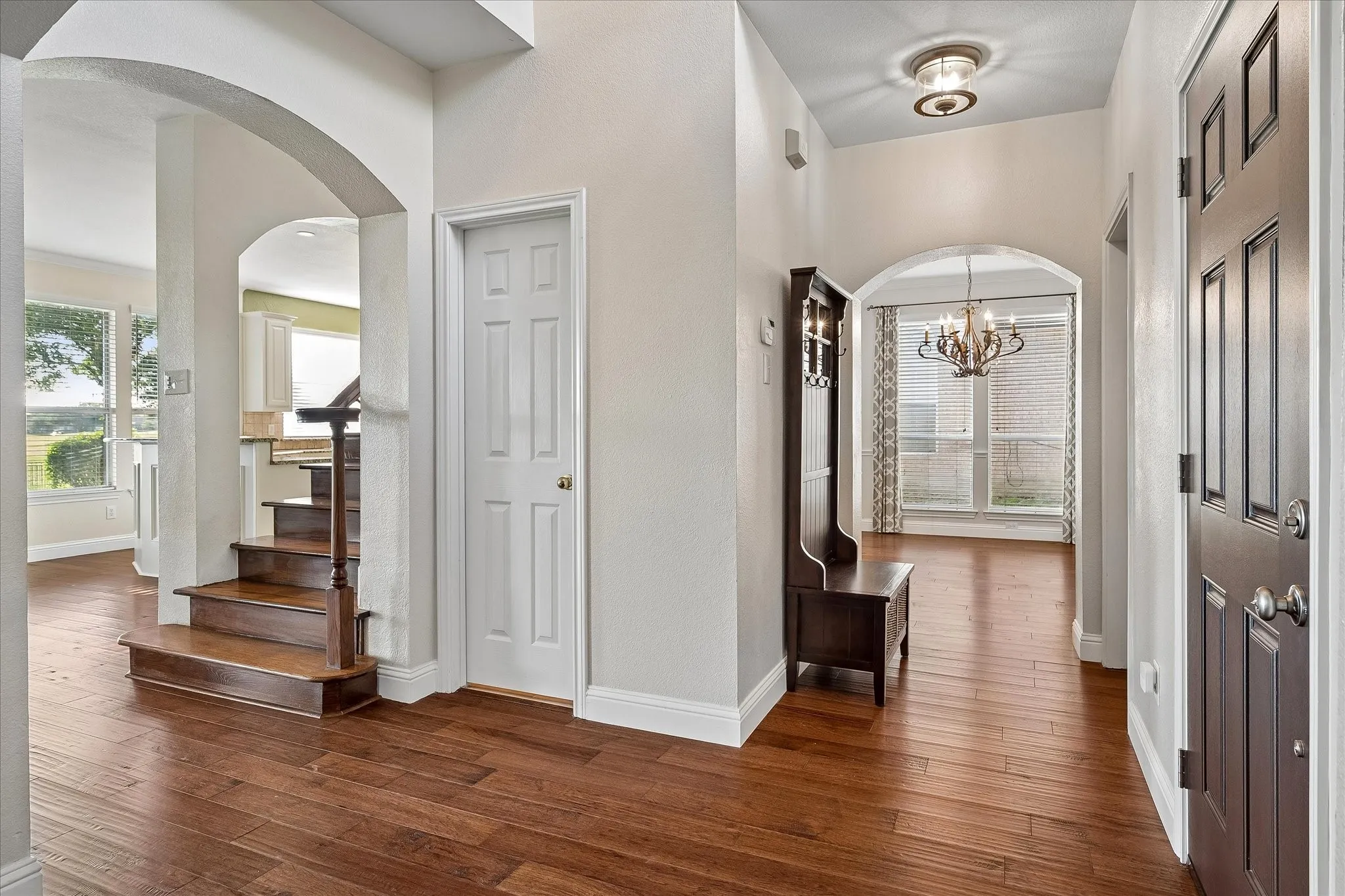 Designed with an open, inviting floor plan.  View from Foyer looking past the vestibule to the Formal Dining Room. Beautiful engineered hardwood flooring.