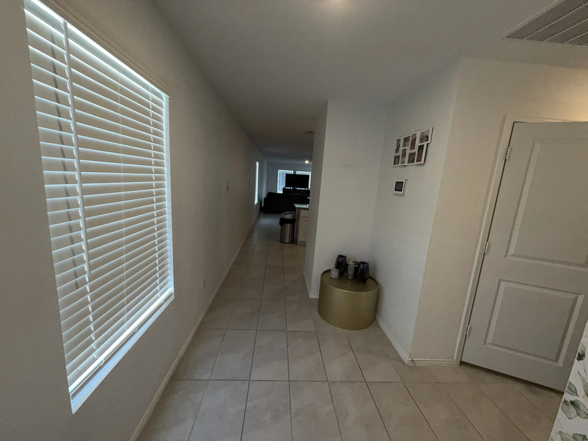 Tiled flooring extending through a light-filled hallway