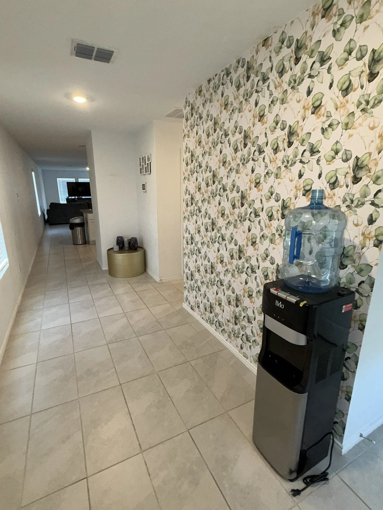 Entryway featuring ceramic tile flooring, recessed lighting, and a decorative botanical-patterned accent wall
