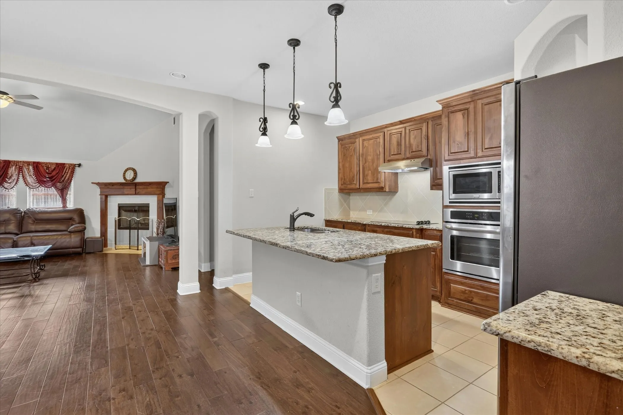 Kitchen island with granite countertop and pendant lighting