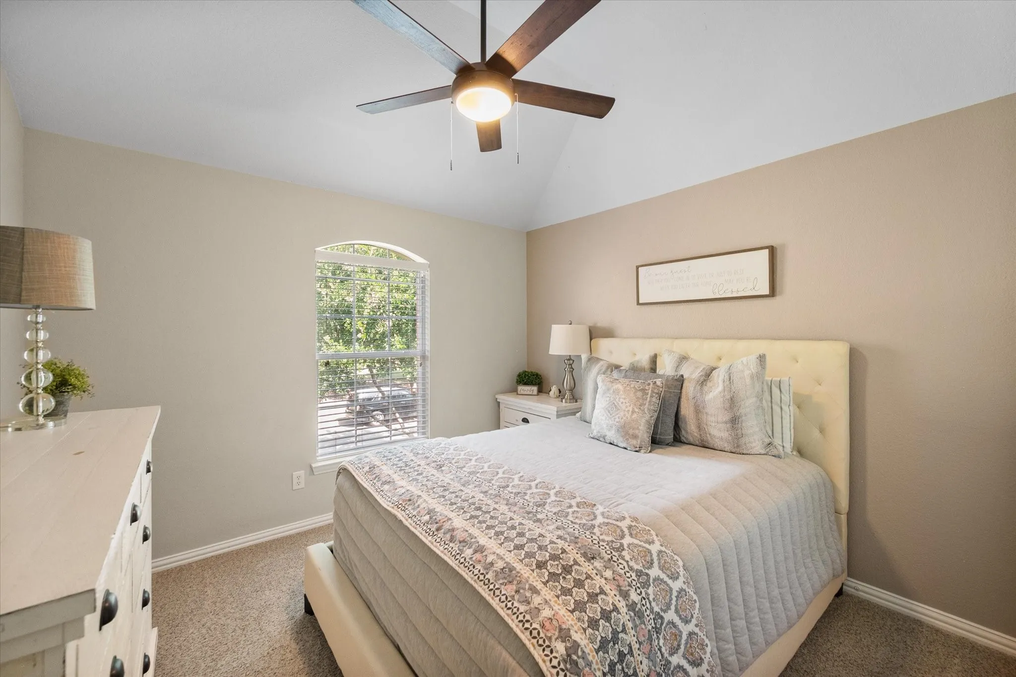 Bedroom with a wood-finish ceiling fan and integrated lighting!