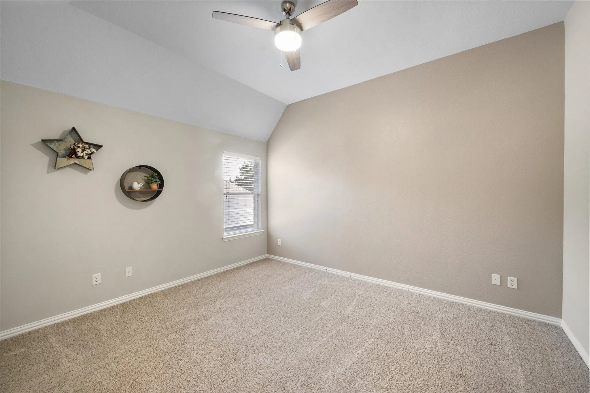 Bedroom with neutral wall tones and plush carpeting!