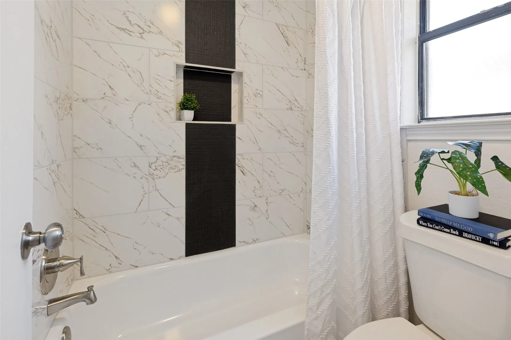White bathtub with brushed nickel fixtures