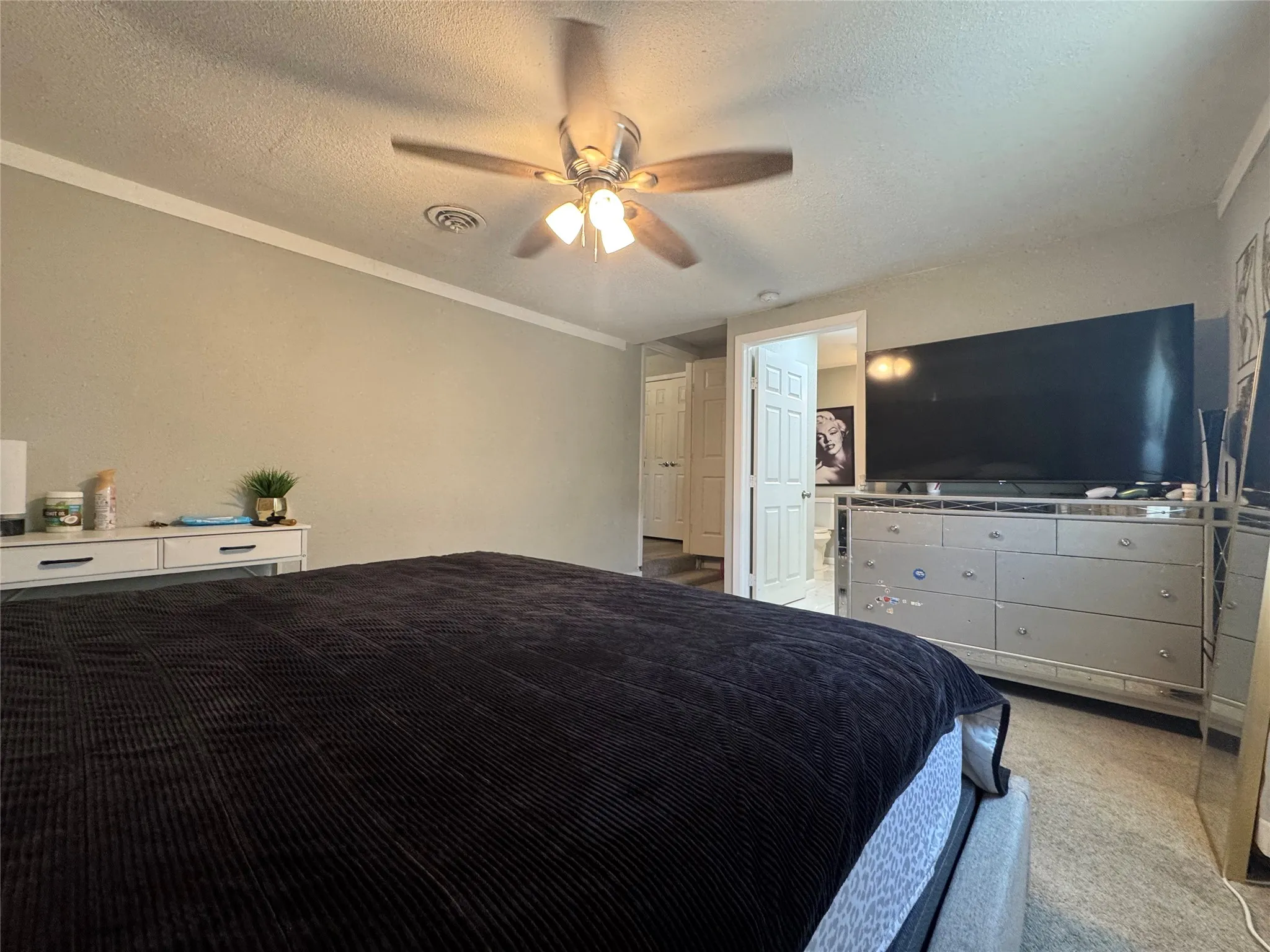 Bedroom featuring crown molding and a ceiling fan