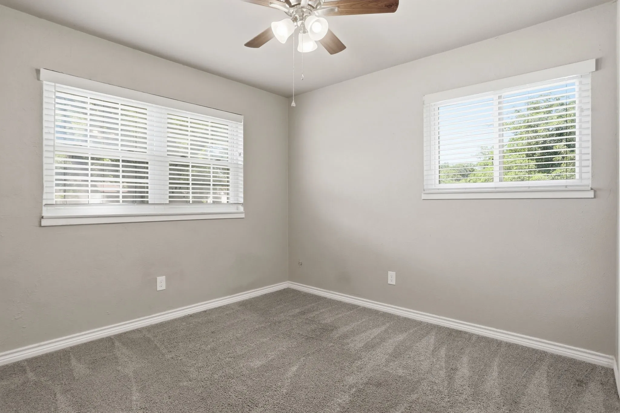 Neutral-toned walls complement the gray carpeting