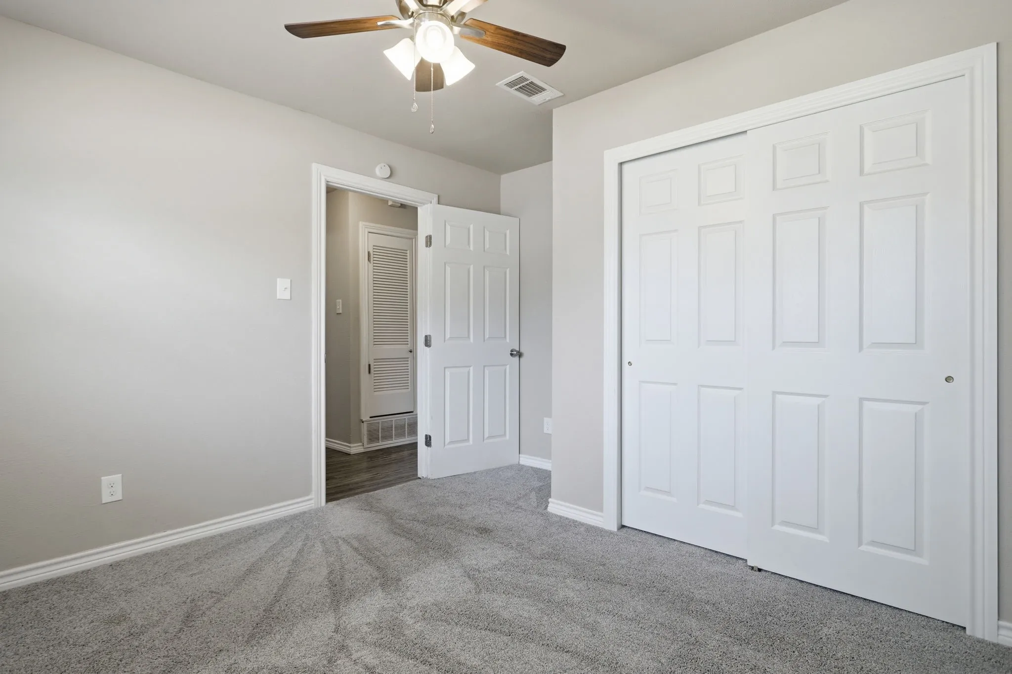 Room with light gray wall paint and matching baseboards