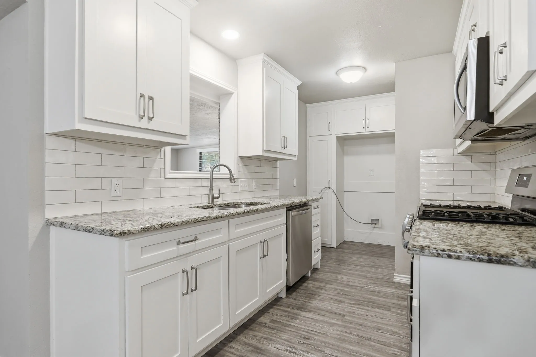 White cabinetry w/ granite-style countertops