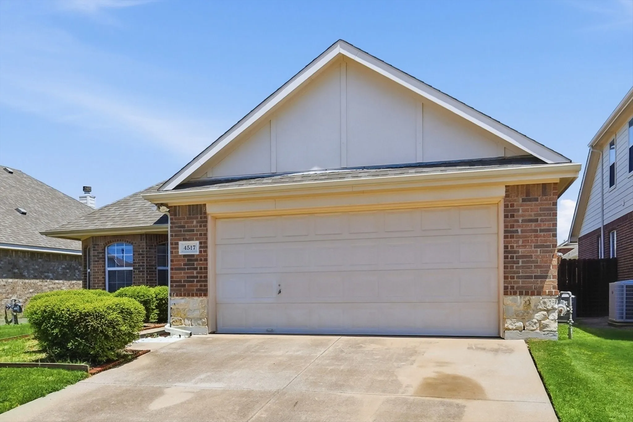 Brick exterior with stone accents and a two-car garage