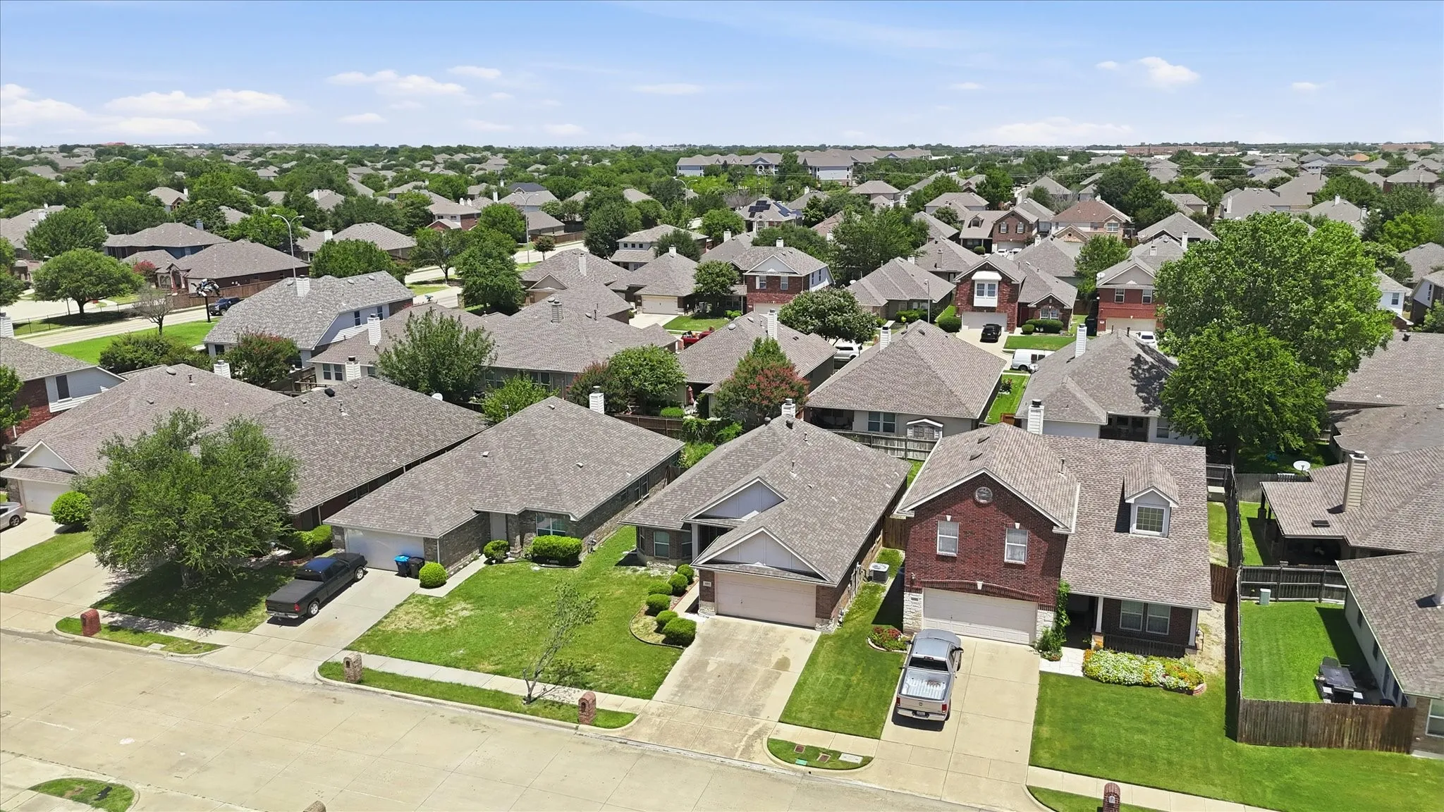 Residential neighborhood with a variety of single-family homes featuring shingle roofs and established landscaping