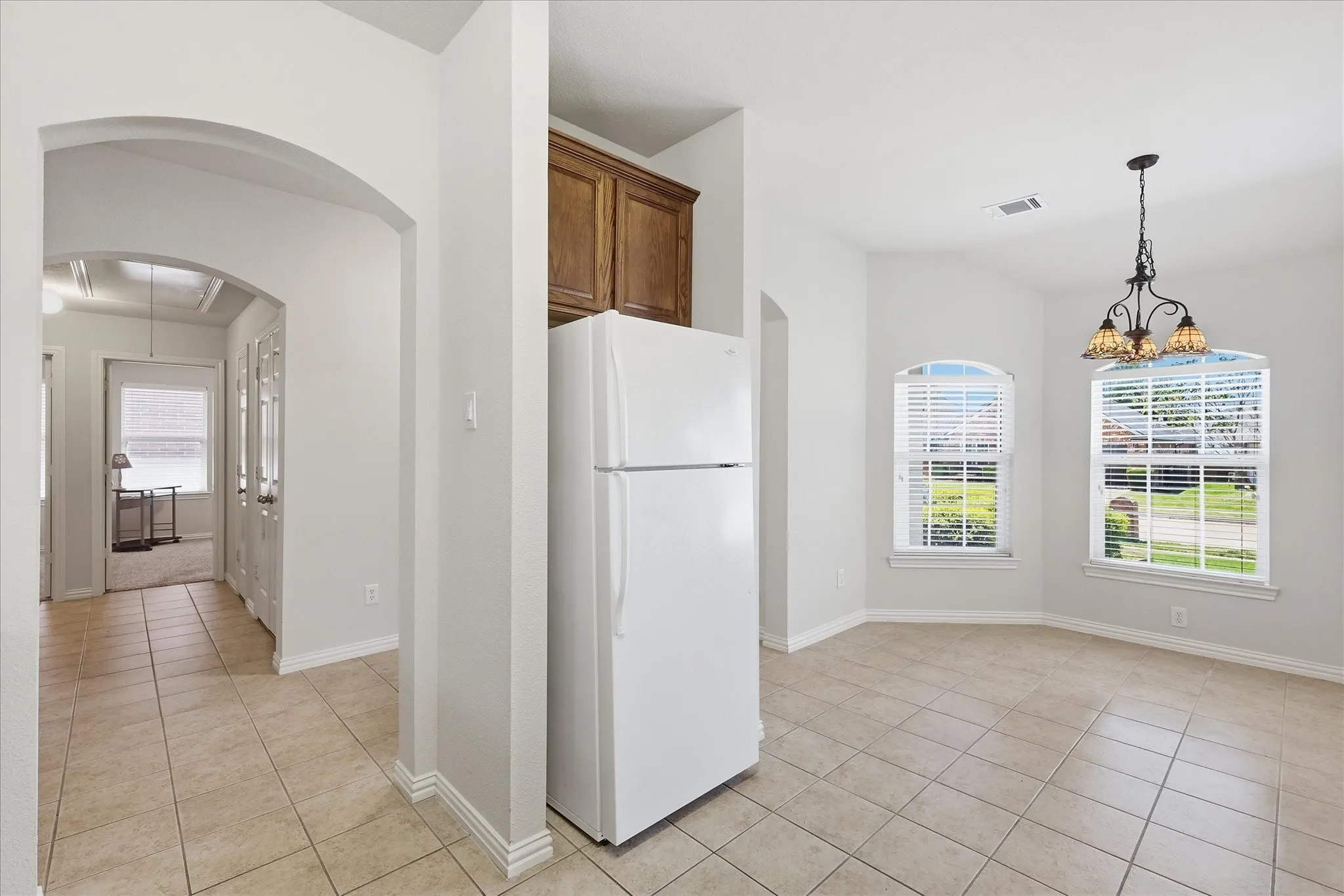 Tile flooring extending through an arched entryway