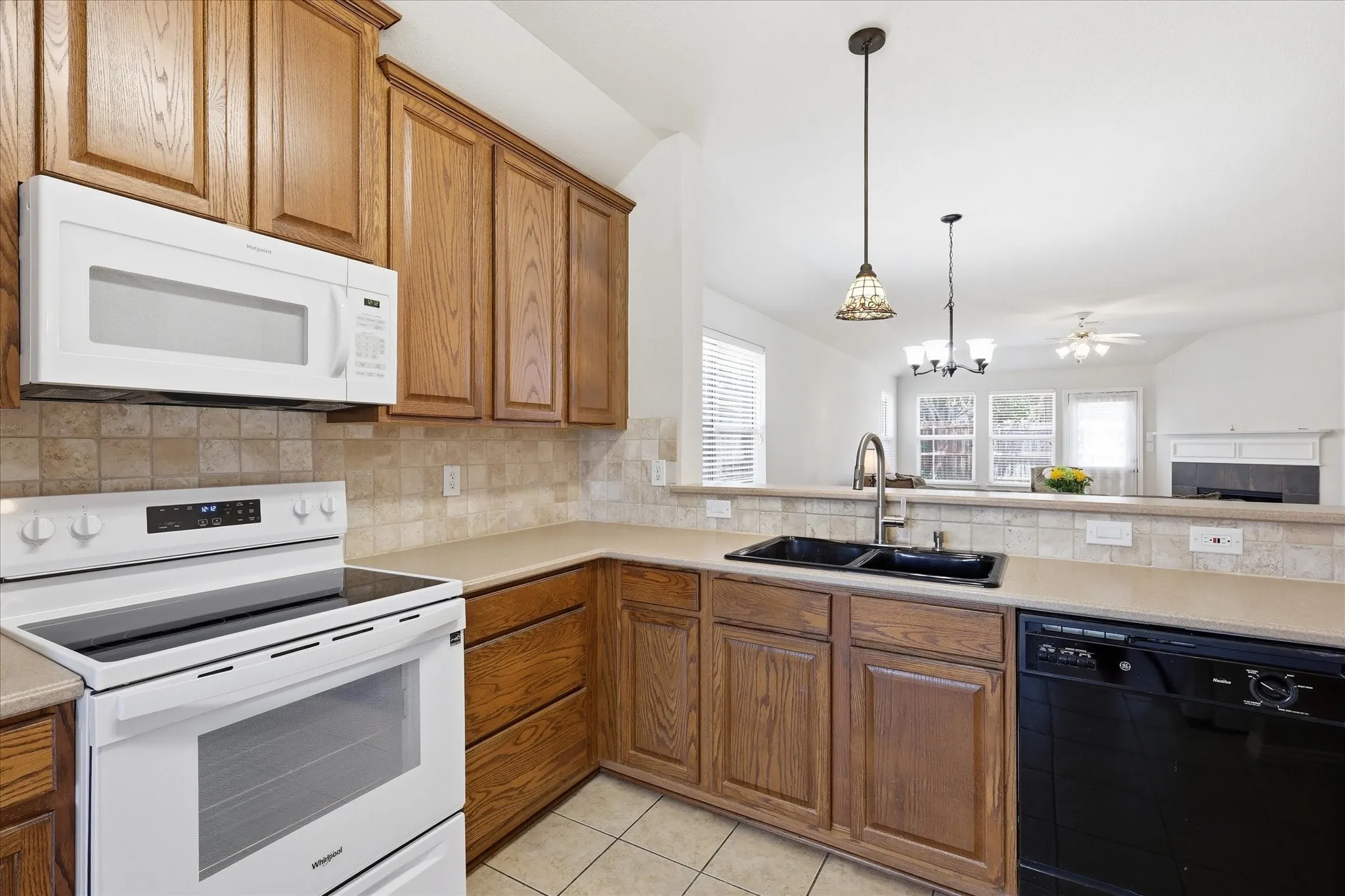 Kitchen featuring wood cabinetry, light countertops, and tile flooring
