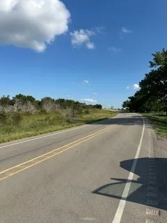 Paved road frontage with clear sky overhead