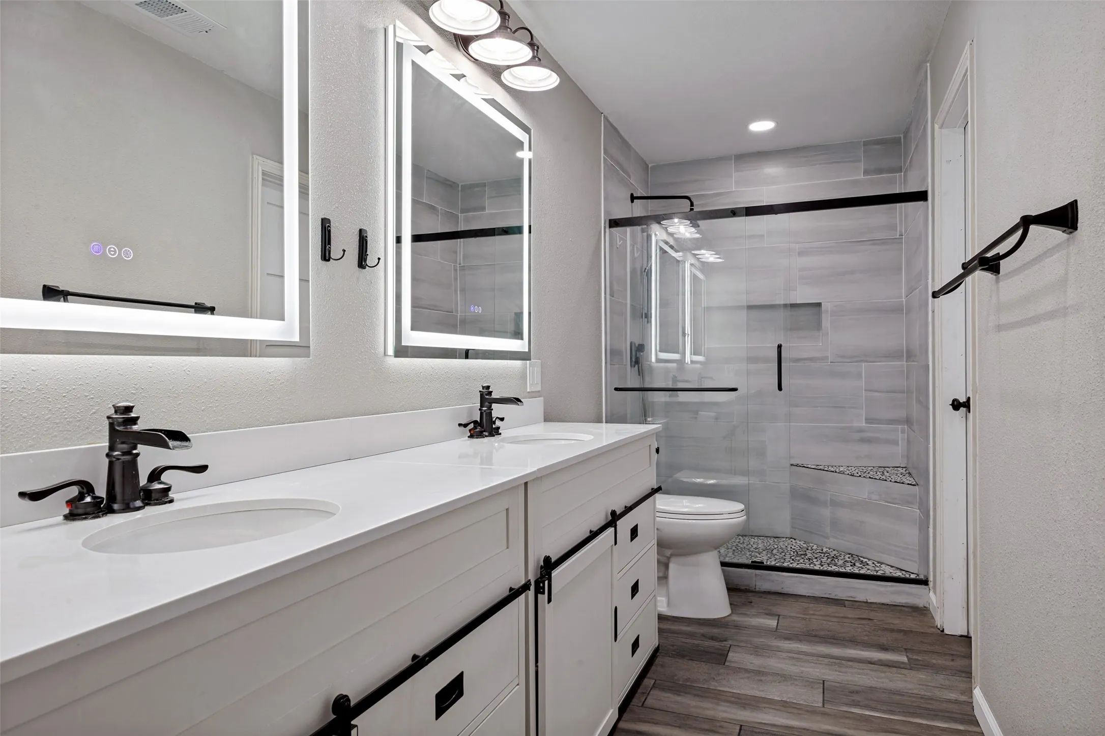 Double vanity with white cabinetry, white countertops, and integrated sinks