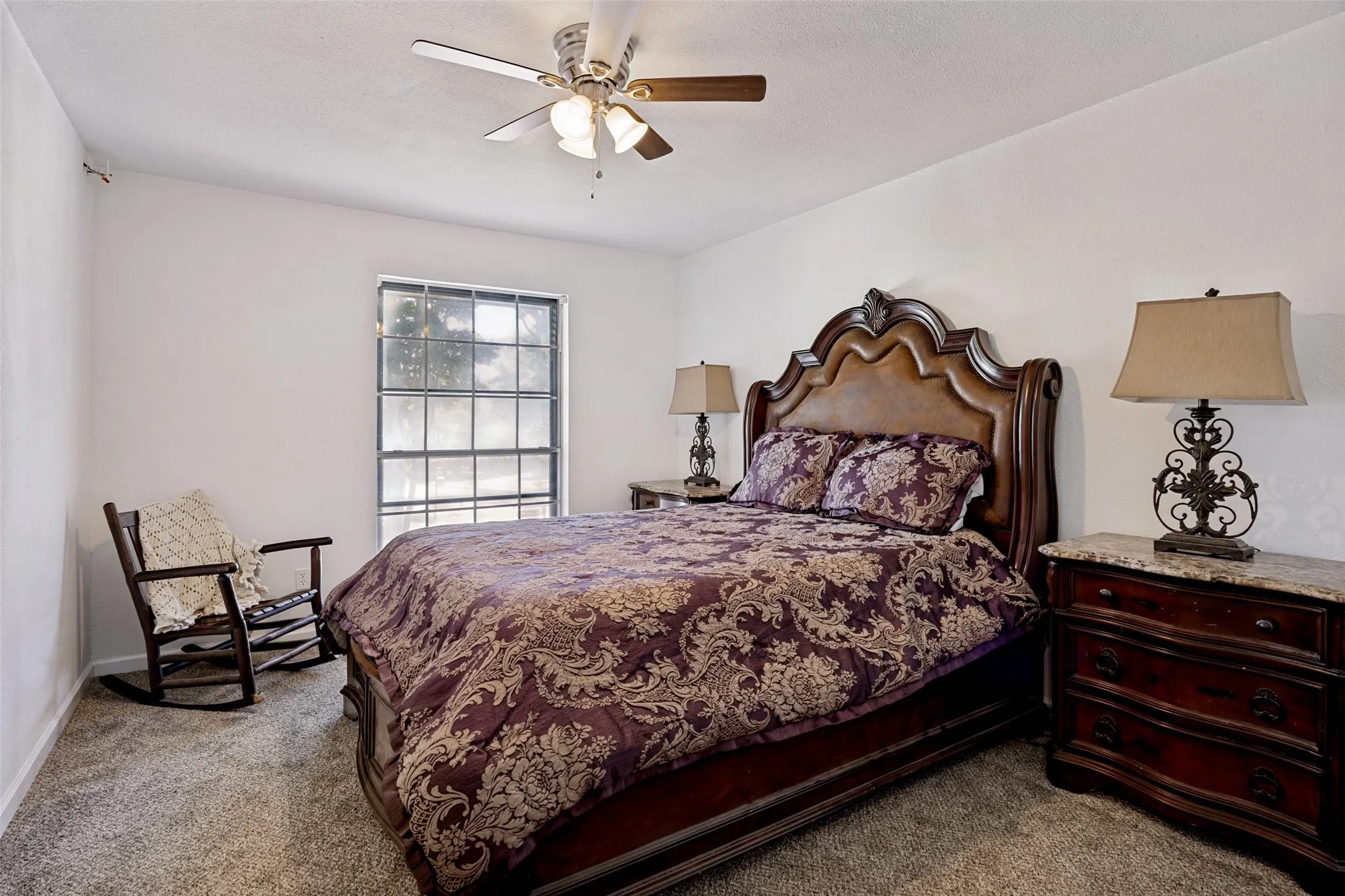 Carpeted bedroom with a ceiling fan, ensuite bathroom with walk-in shower