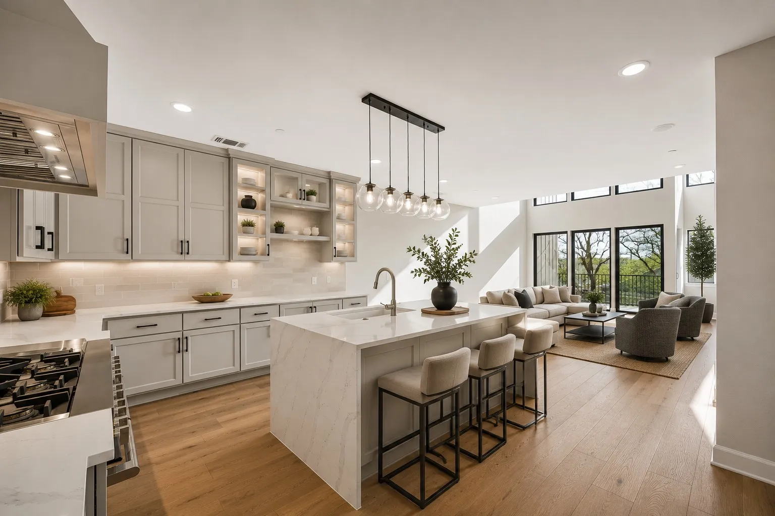 Gourmet kitchen with light-toned cabinetry, a waterfall island, and built-in stainless steel appliances