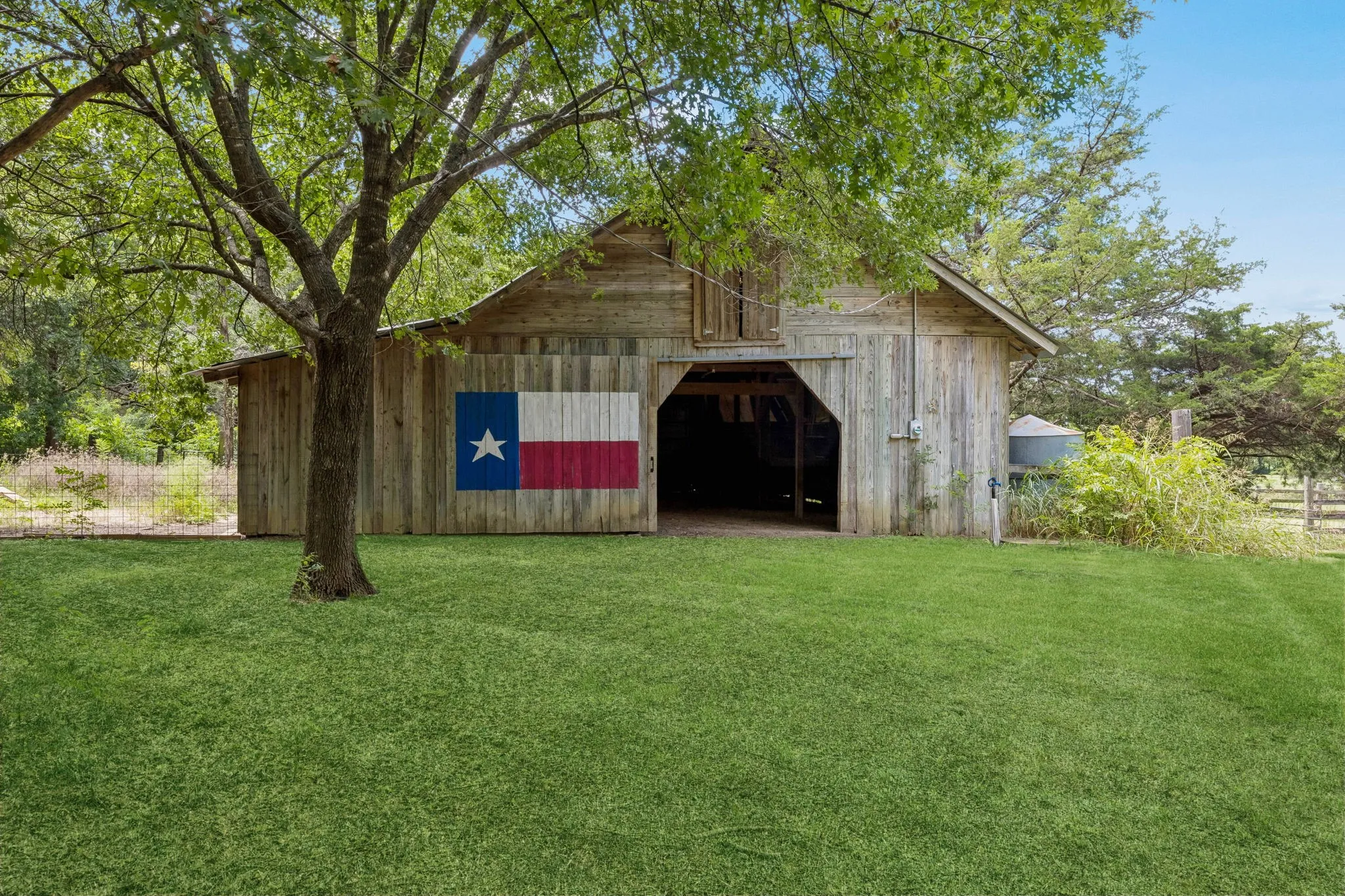 Barn with electricity and water, a tack room, a loft, stalls, and currently outfitted for goats and chickens