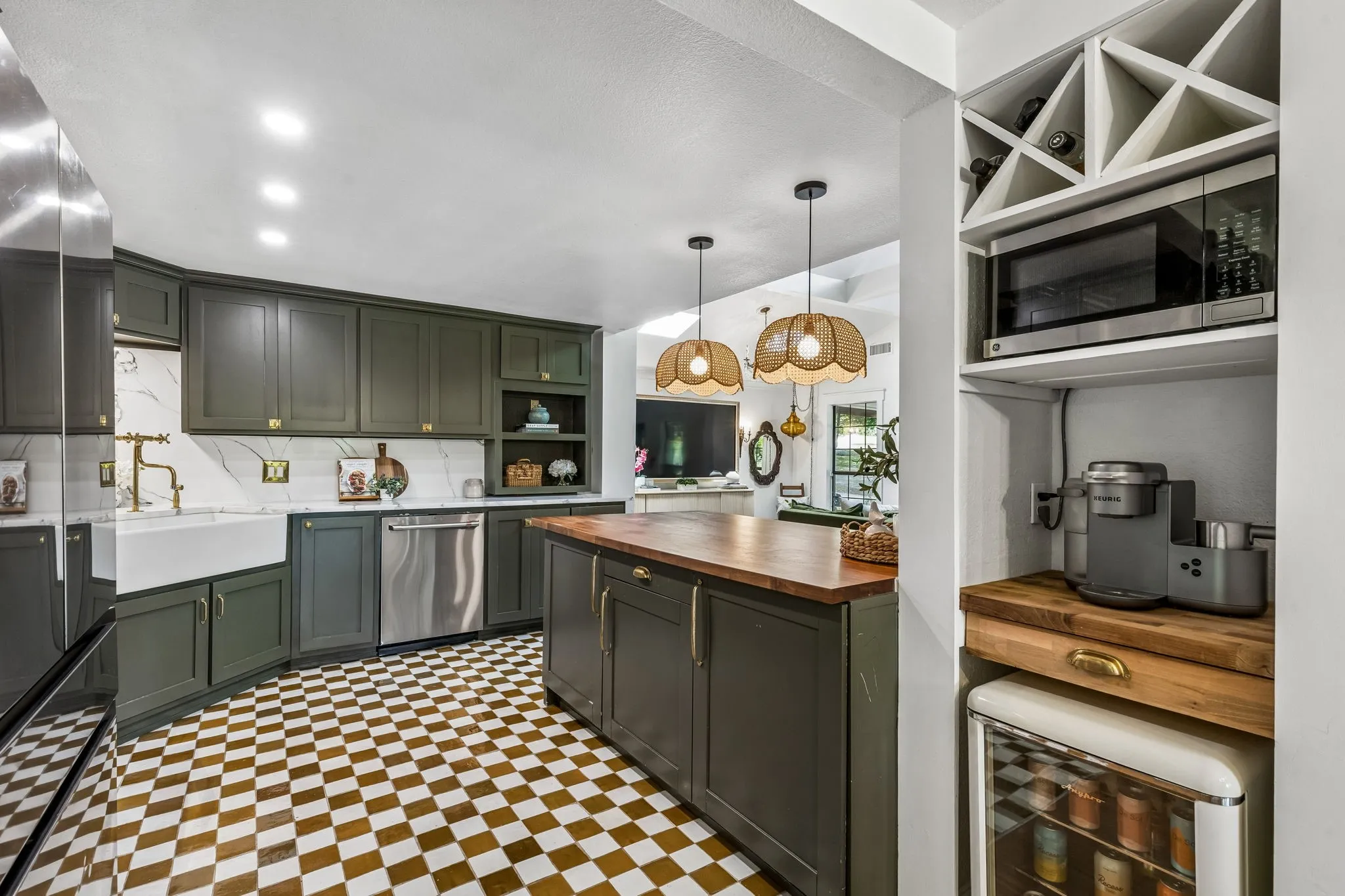 Fully updated kitchen with custom cabinets, quartz counters, zellige tile floors, high end hardware, farmhouse sink, and new appliances