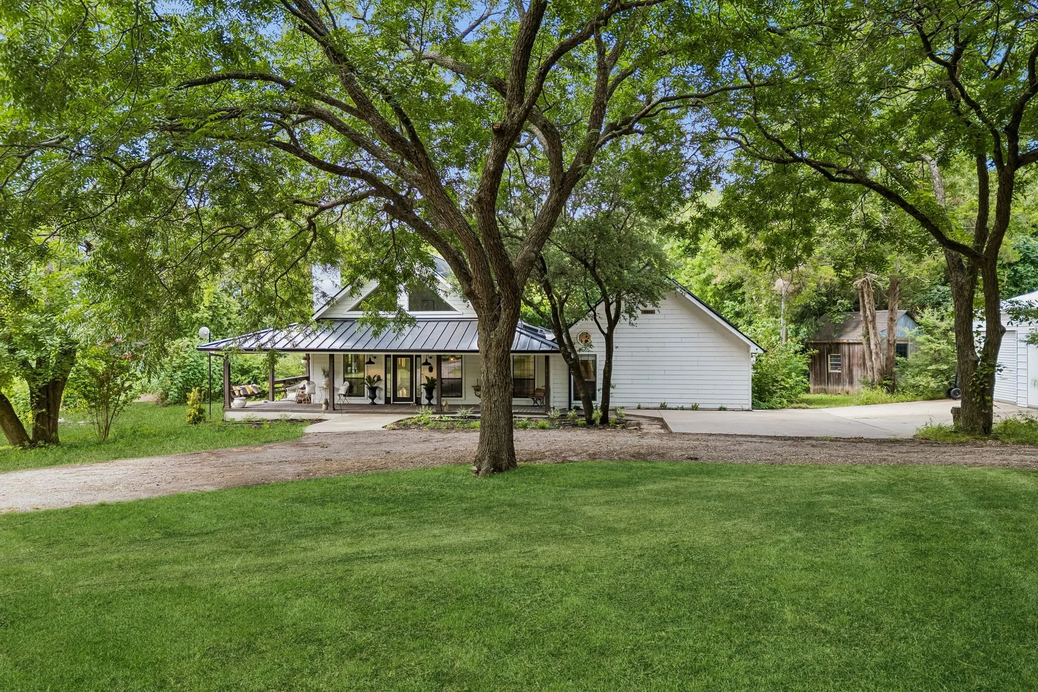 Tucked back from the main road, a tree lined and charming gravel path leads you home.