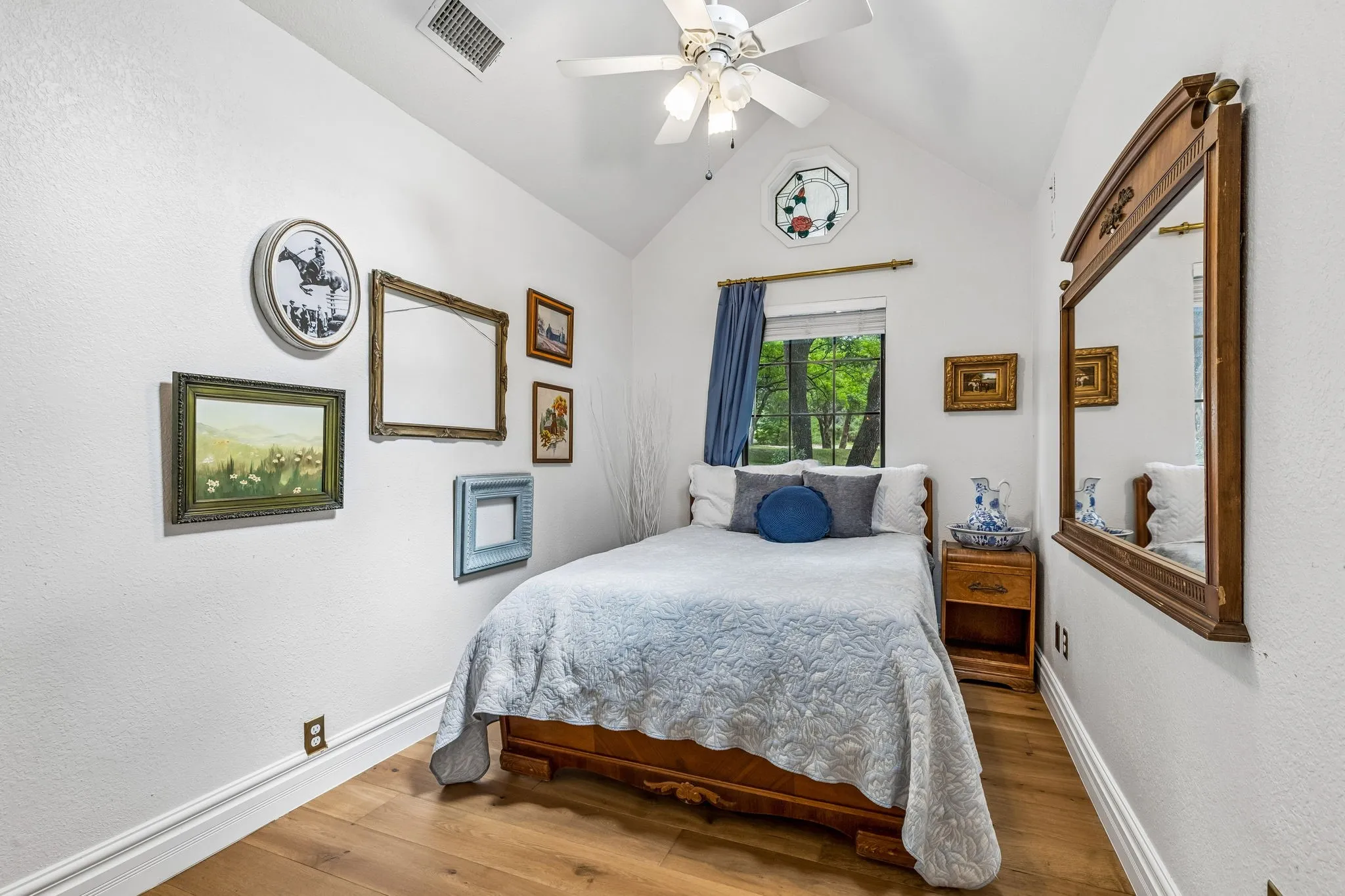 Inviting secondary bedroom with a beautiful stained glass window.