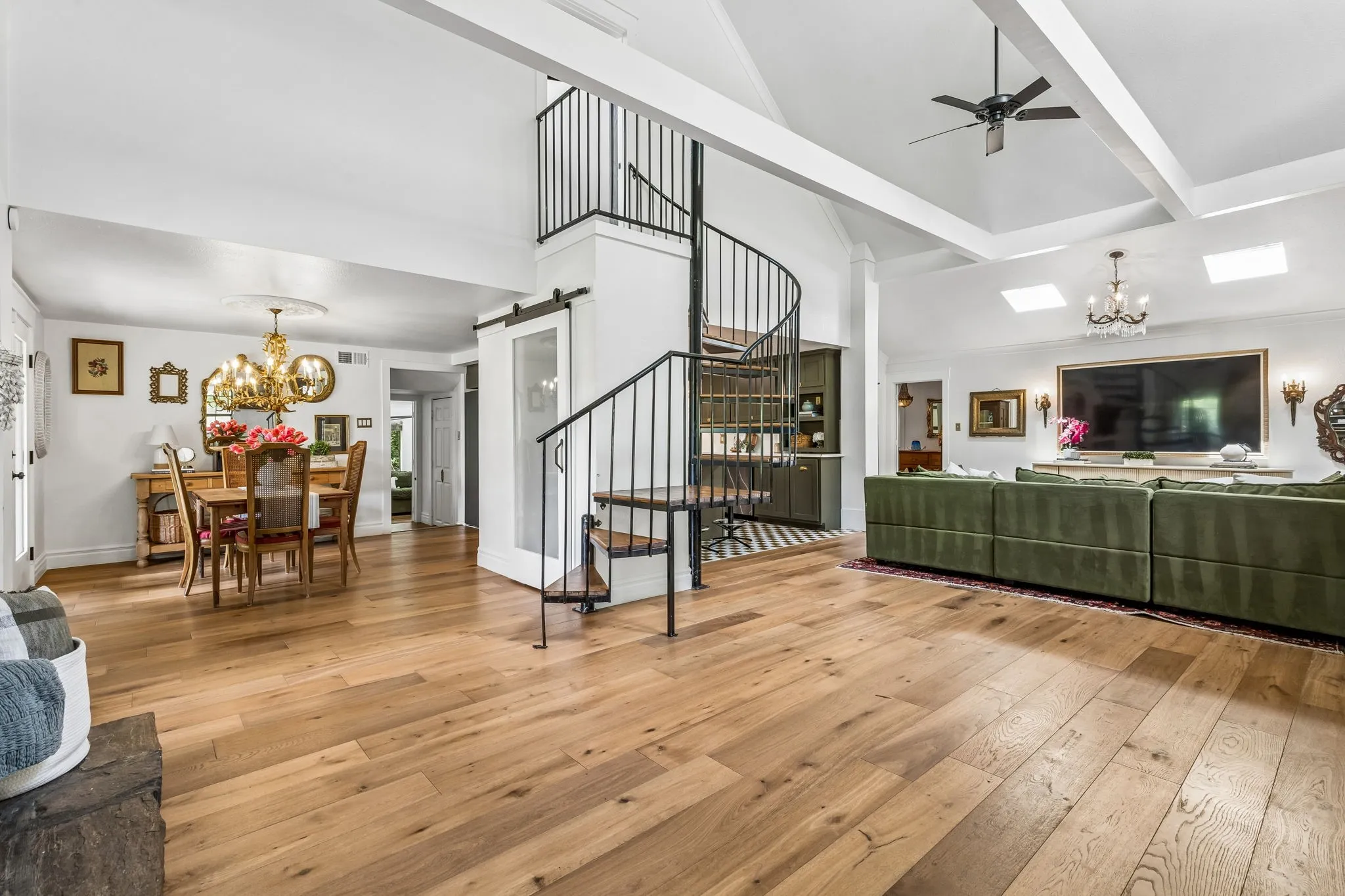 Enter to an open floorplan with the living room, sitting room, dining room, and kitchen