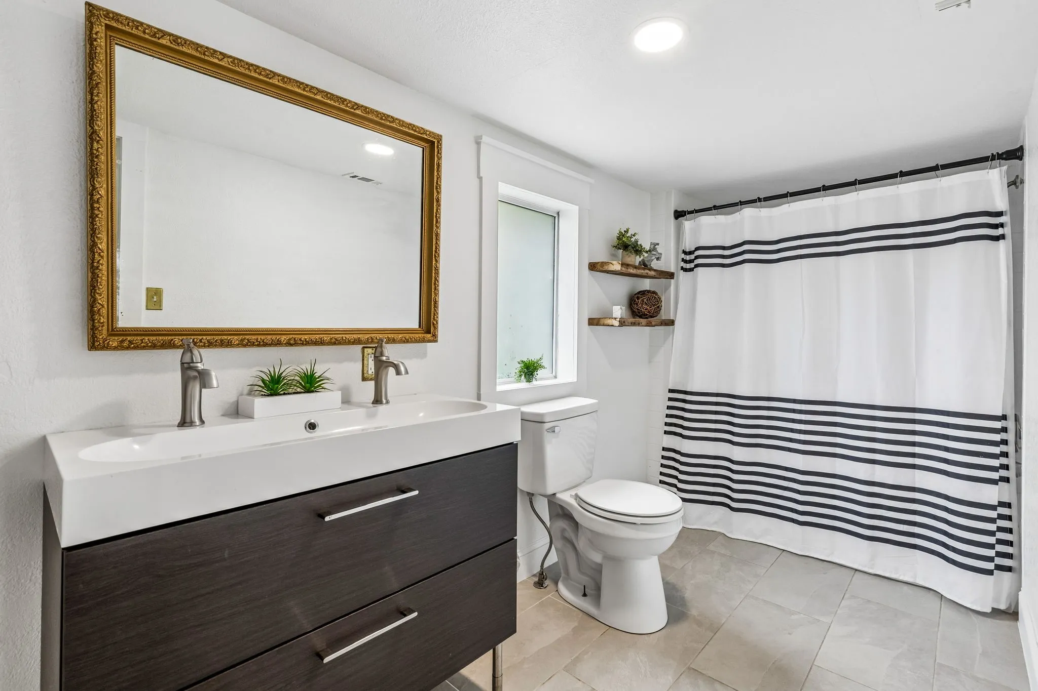 Ensuite bath with dual faucets off of the fifth bedroom