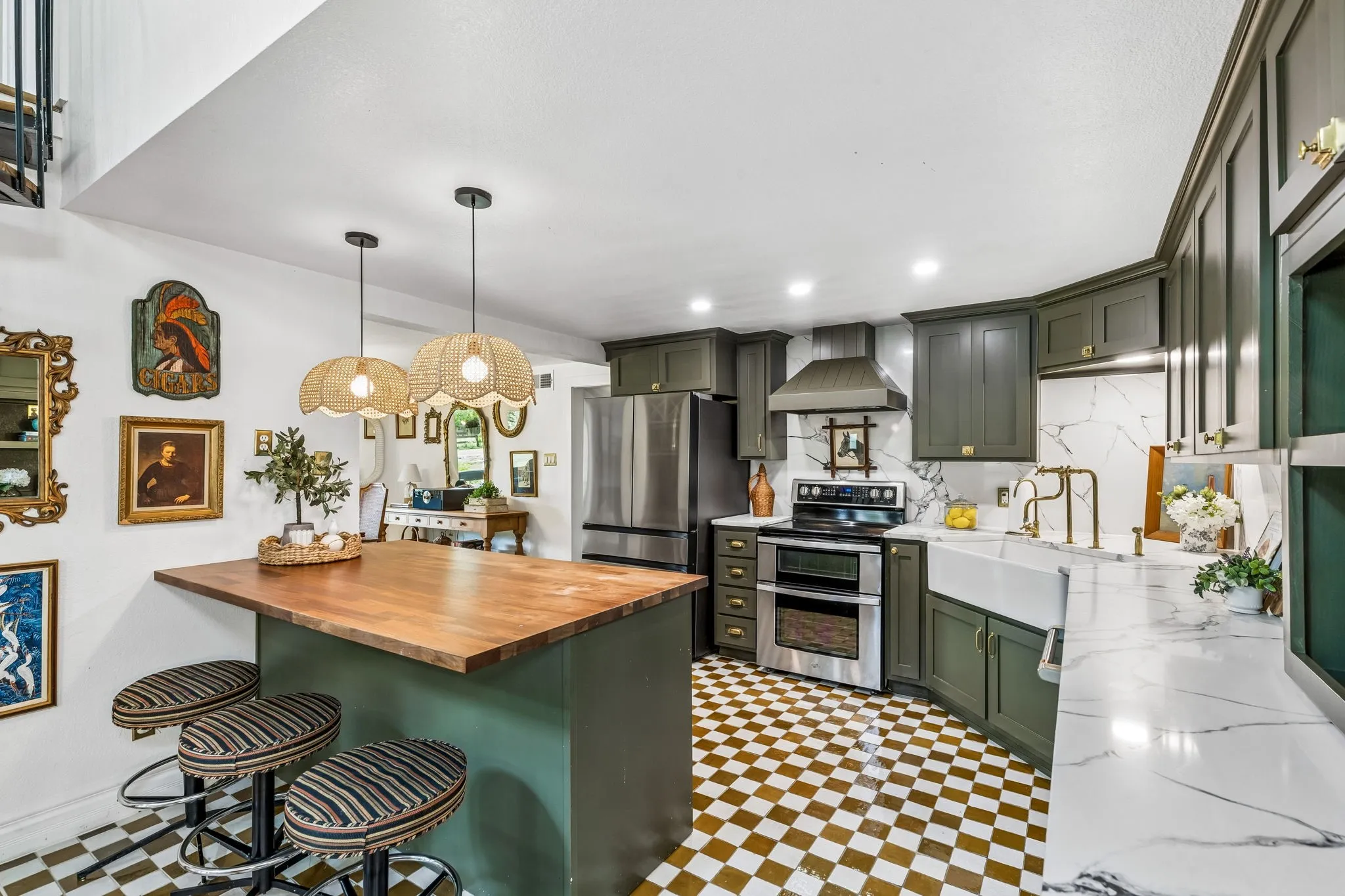 Fully updated kitchen with custom cabinets, quartz counters, zellige tile floors, high end hardware, farmhouse sink, and new appliances