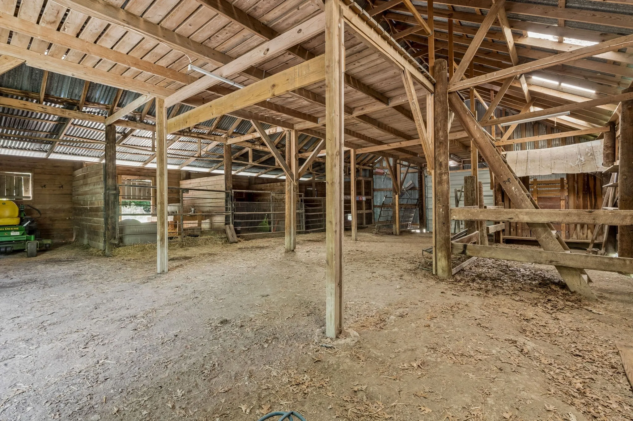 Barn with electricity and water, a tack room, a loft, stalls, and currently outfitted for goats and chickens