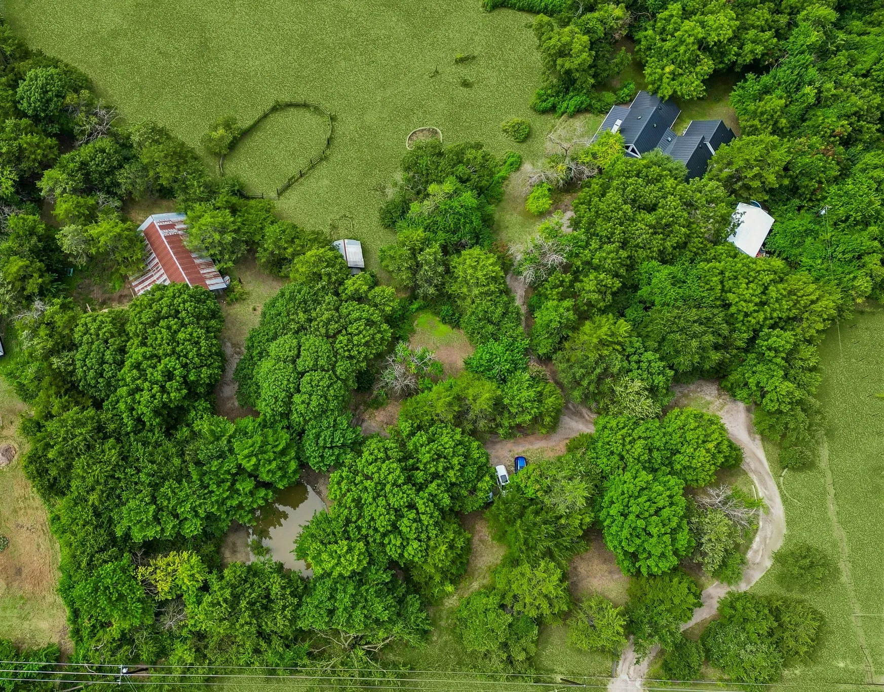 Fully fenced 4.32 private acres includes a pond, seasonal creek, barn, horse corral, garden, firepit, treehouse, garden, 2 acres of open pasture, and more!