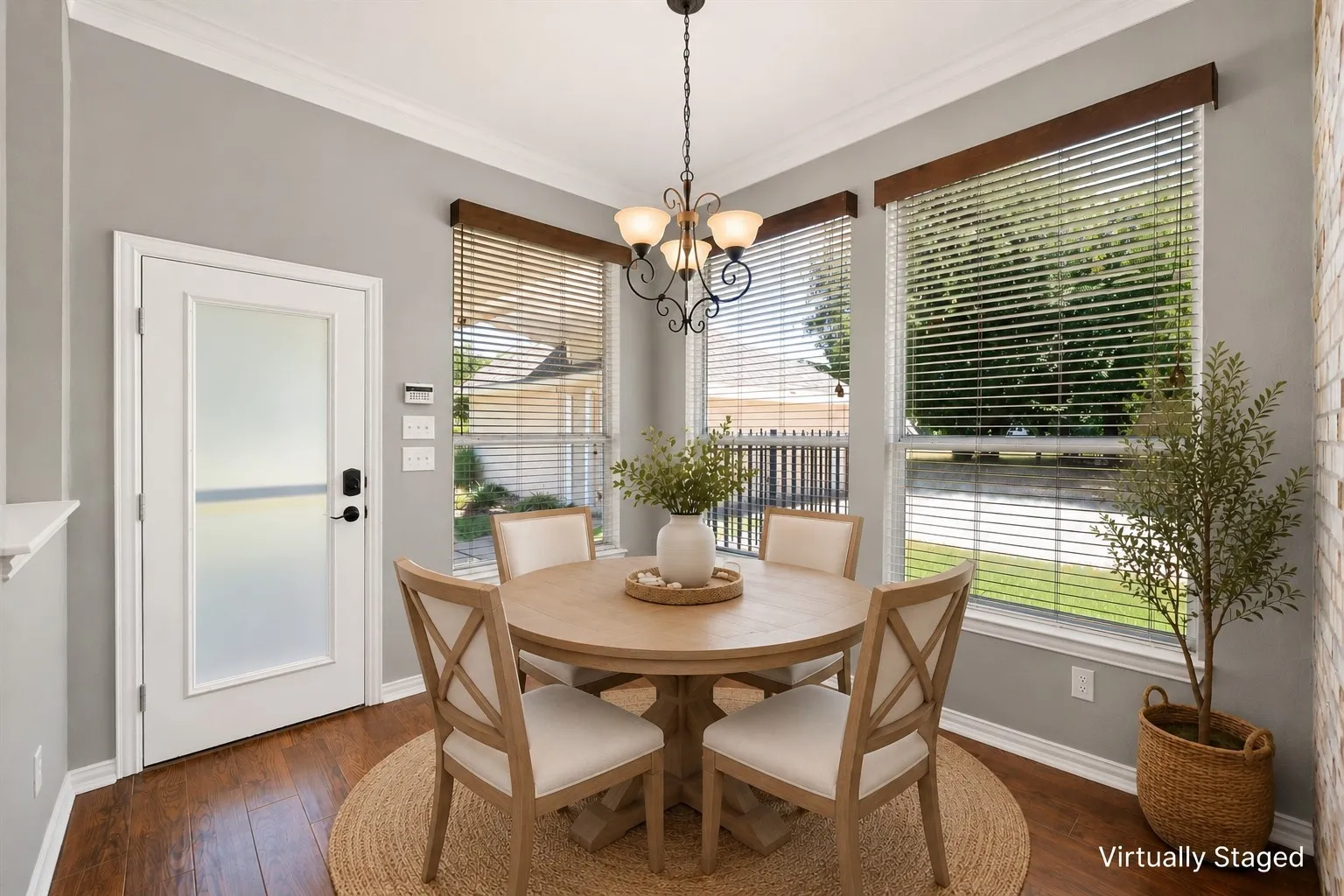 Virtually staged breakfast room creates a welcoming dining nook with windows overlooking the front landscape.