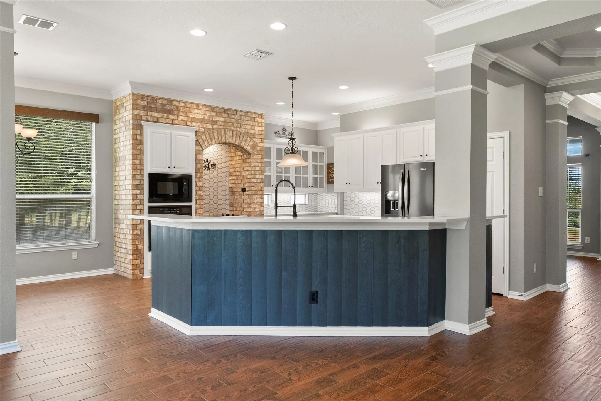 Kitchen and breakfast bar connect beautifully to the living area in this updated Sweetwater Ranch home.