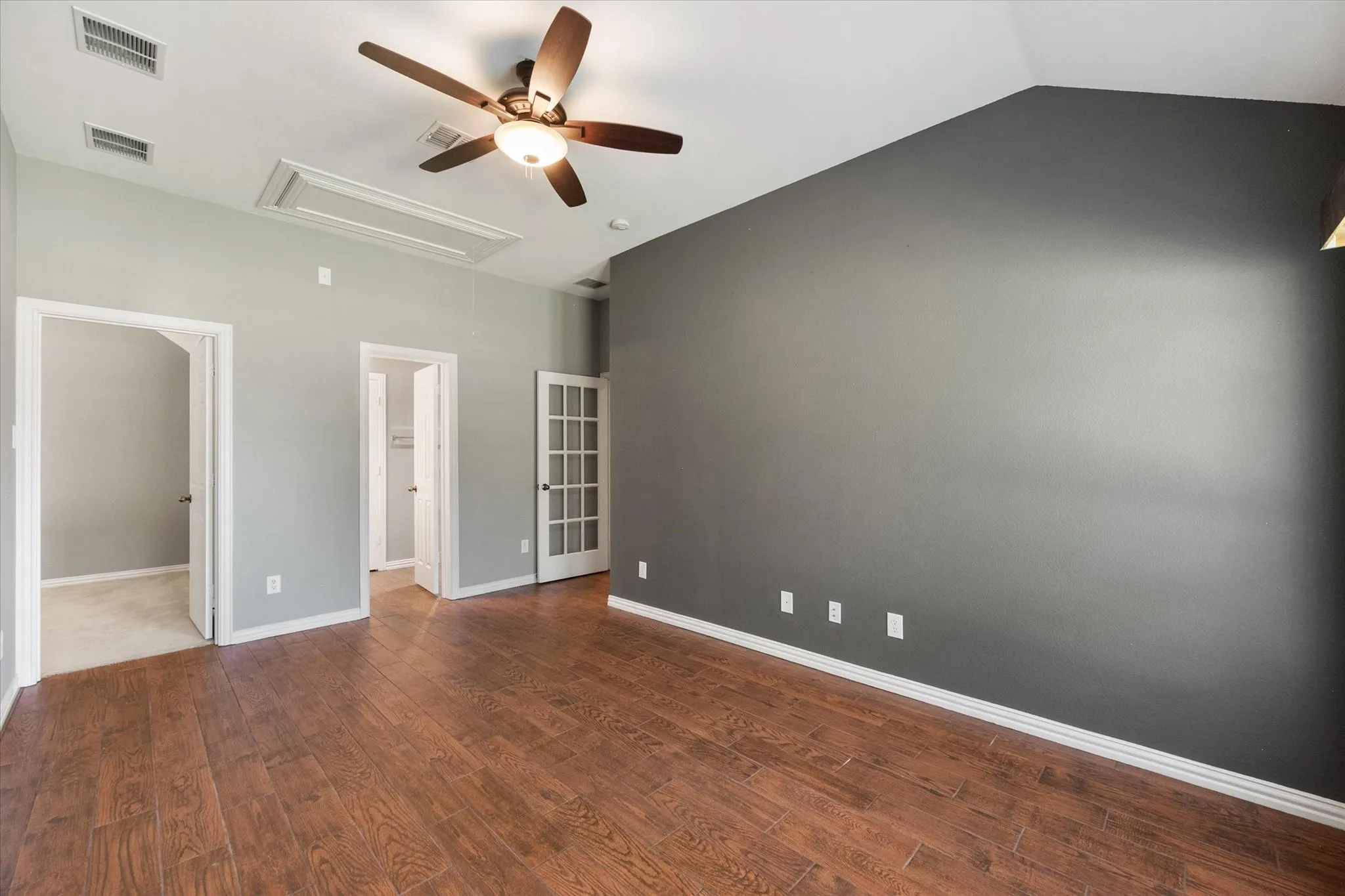 Open flex room with rich wood floors offers space for a study, teen lounge, or additional living area.