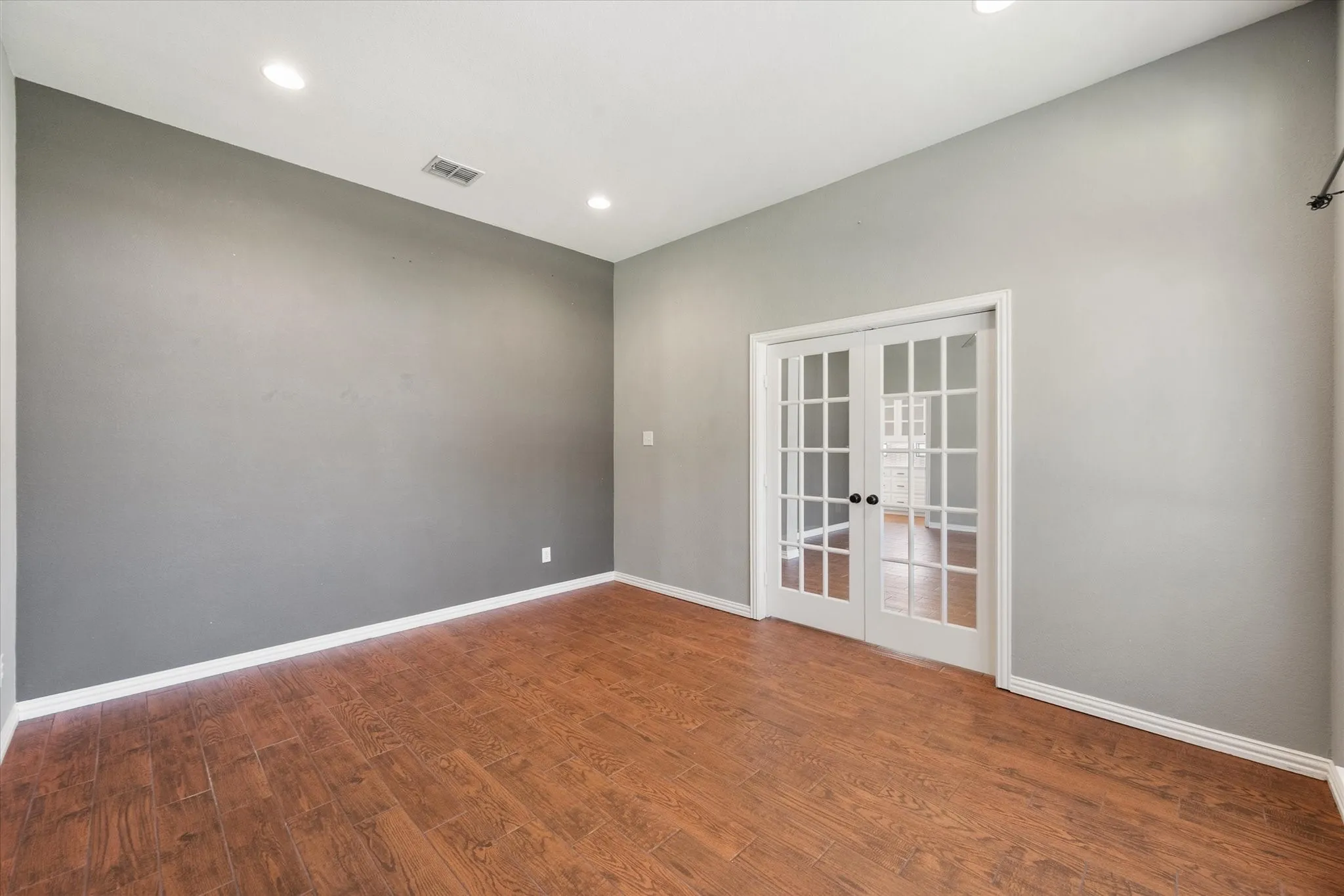 Flexible room with French doors offers an ideal office, study, or playroom.
