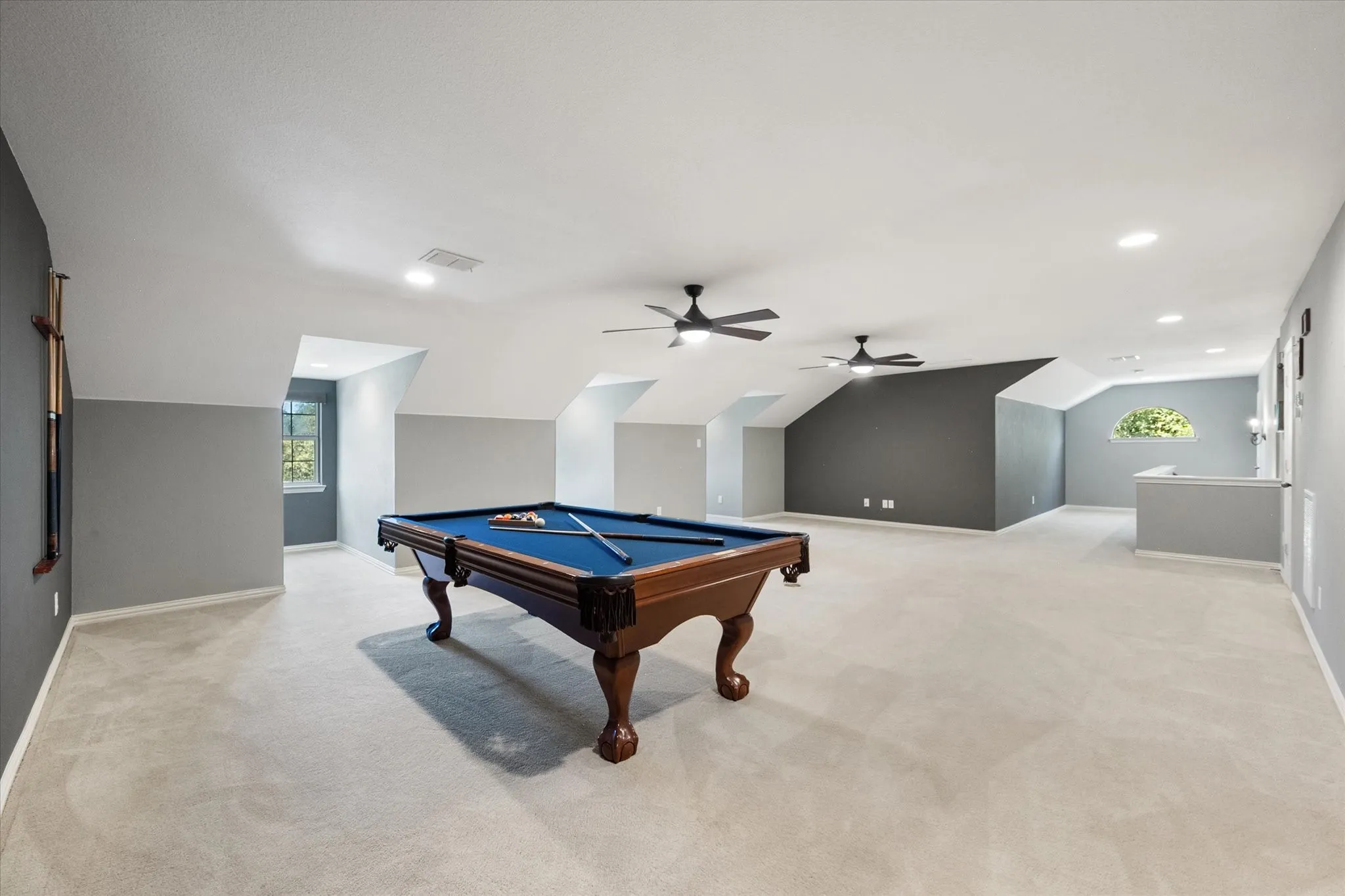 Upstairs game room includes a pool table and expansive space for recreation, media, or weekend guests.
