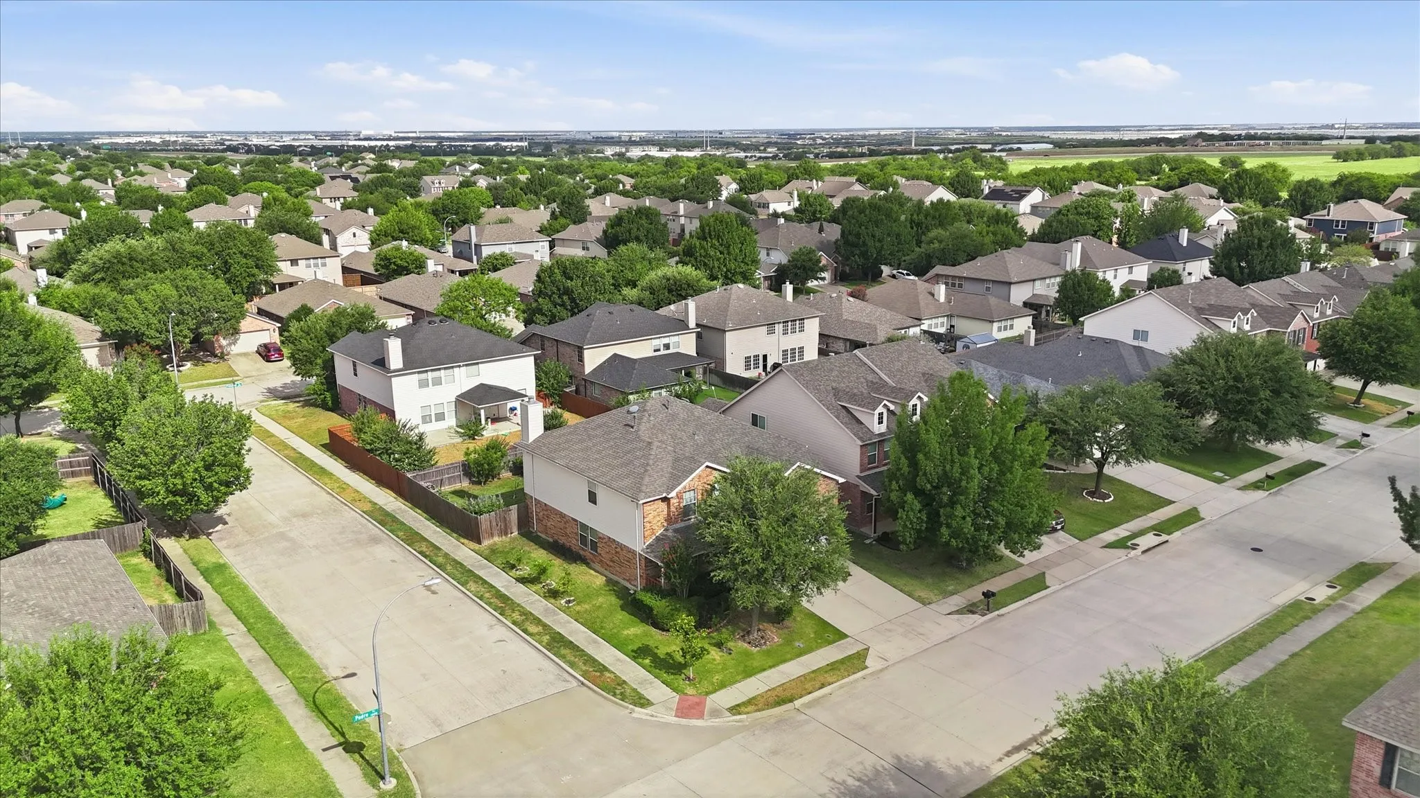 Residential neighborhood featuring multiple single-family homes with mature landscaping and paved streets