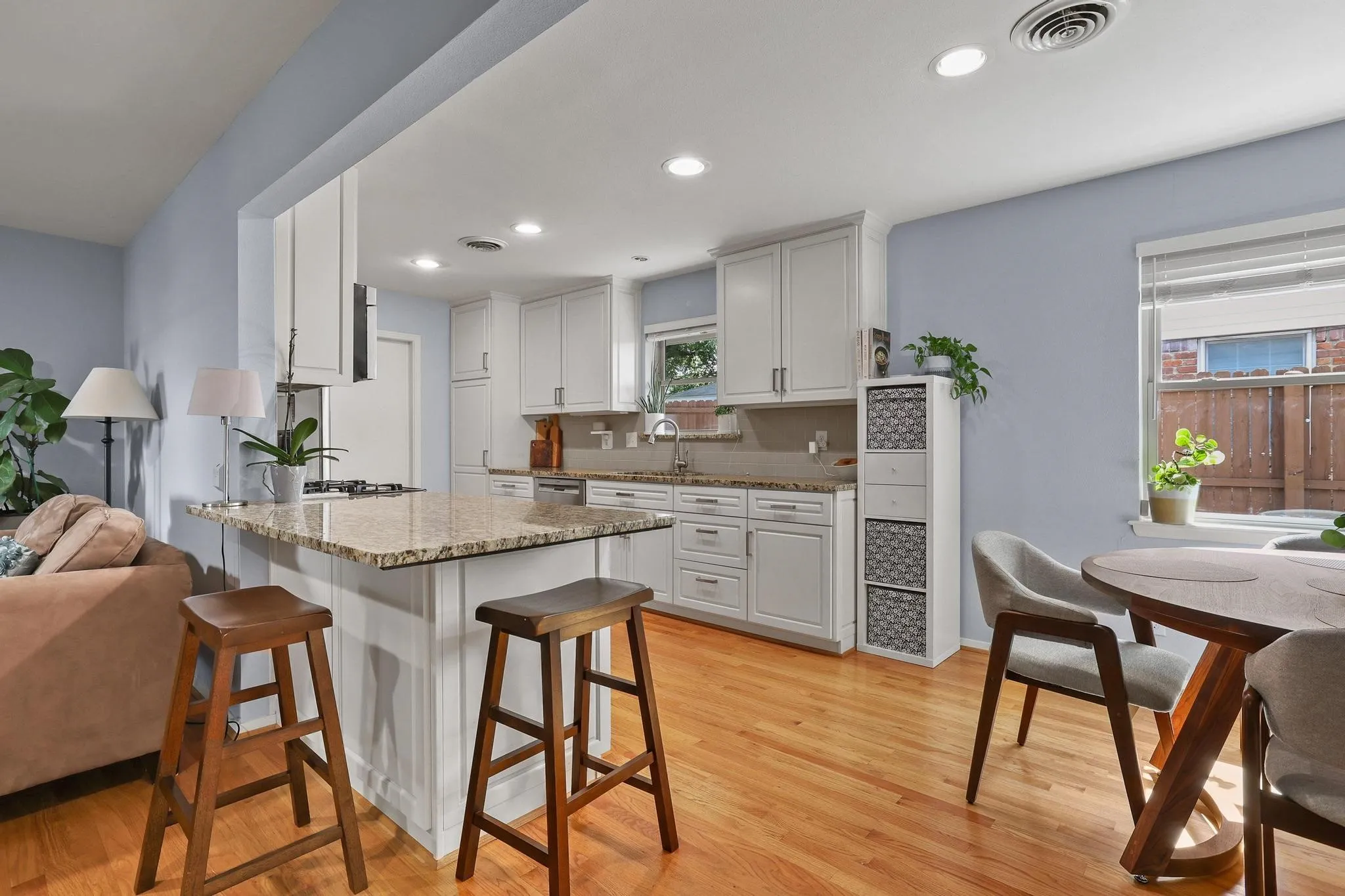 The kitchen keeps everyone connected, with granite countertops, a breakfast bar, and plenty of workspace.