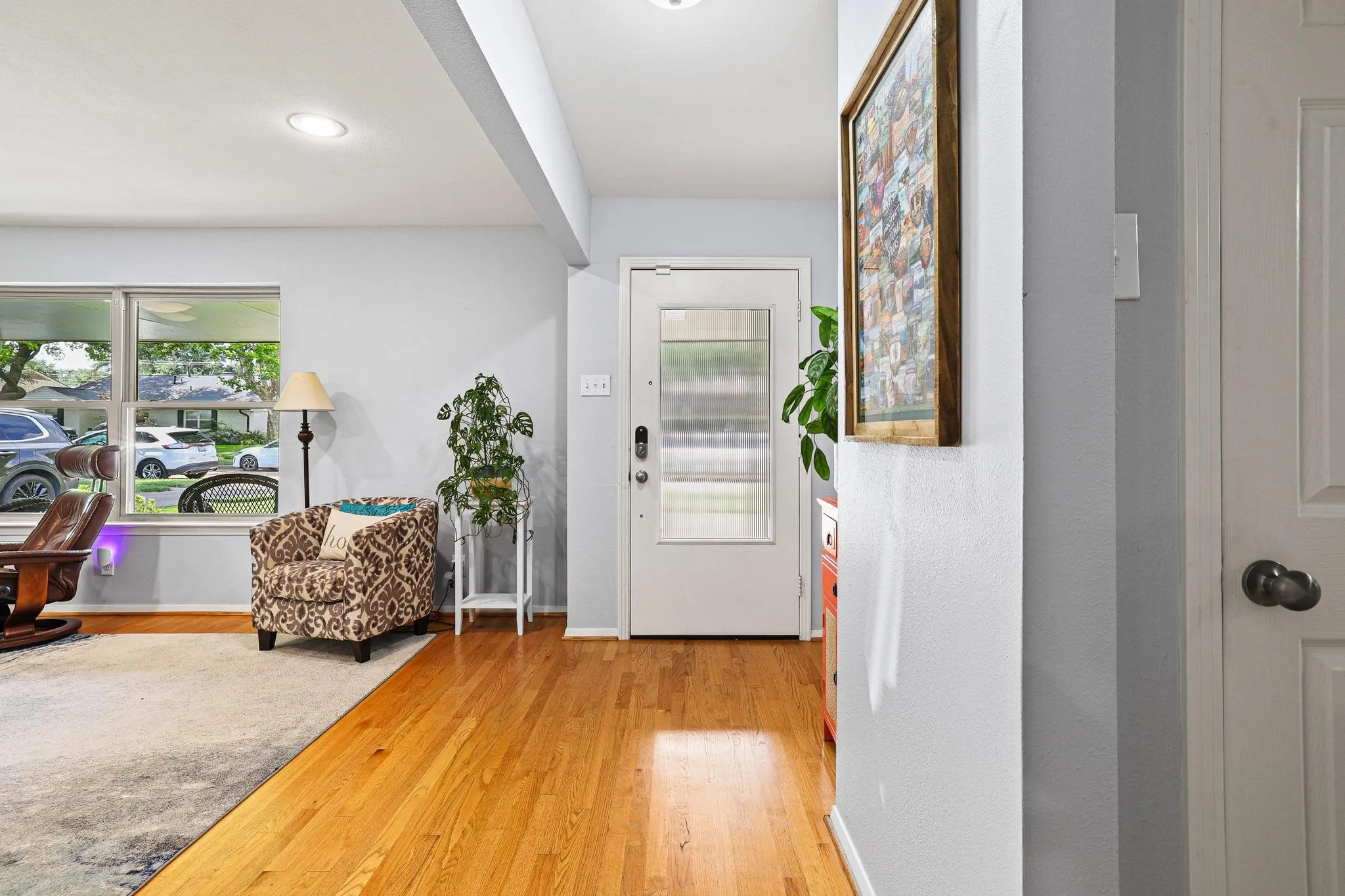 As you enter, you're welcomed by warm hardwood floors and an open, airy feel.