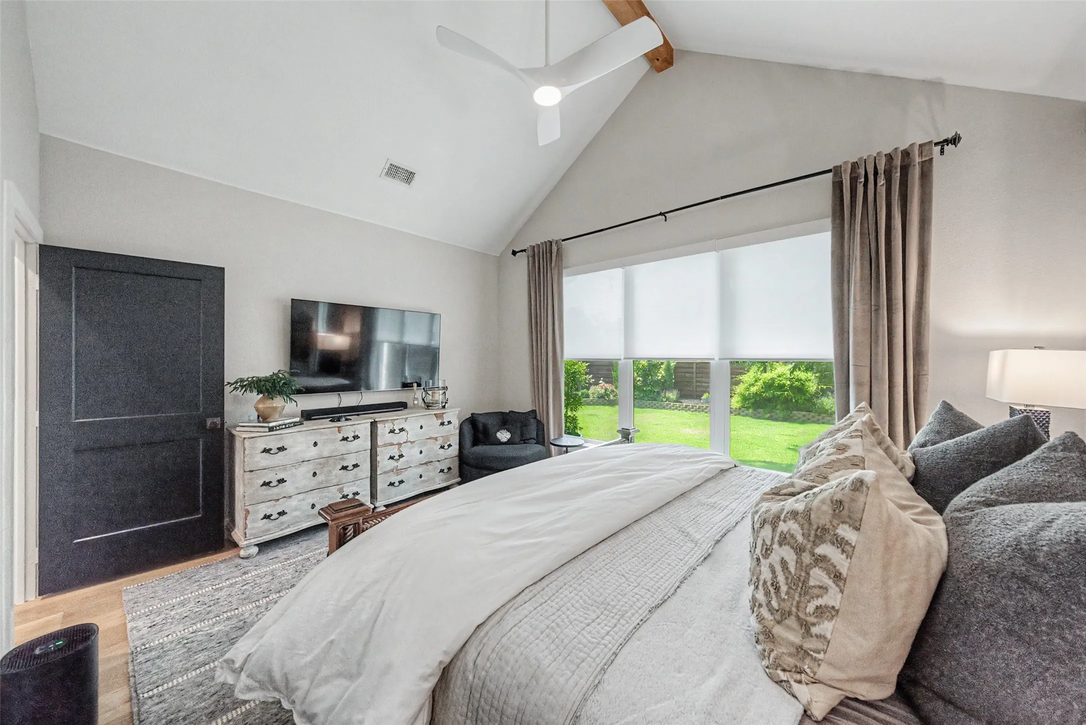 Vaulted ceiling with exposed wood beam and ceiling fan