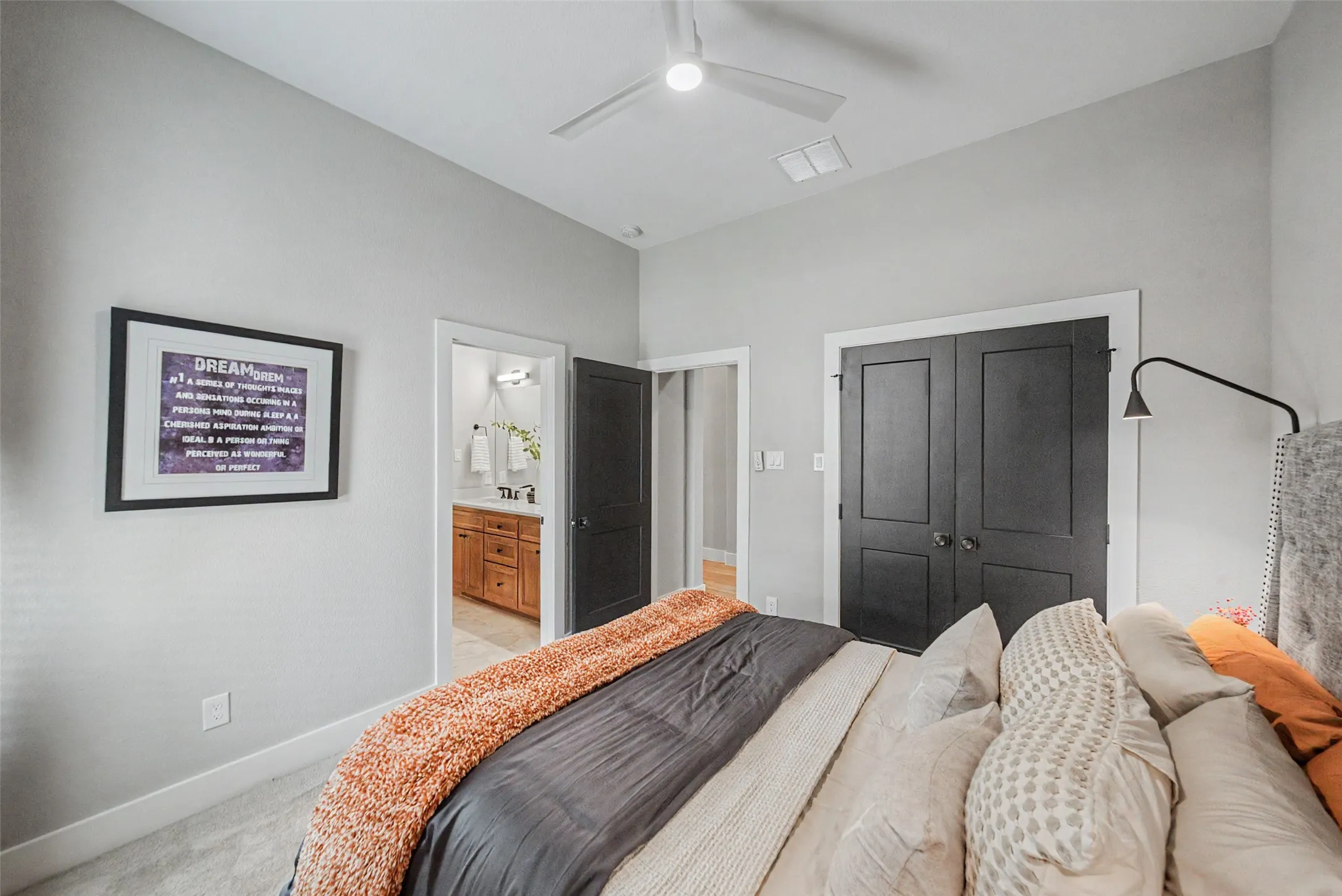 Carpeted room with light gray walls, a ceiling fan with light, and white trim