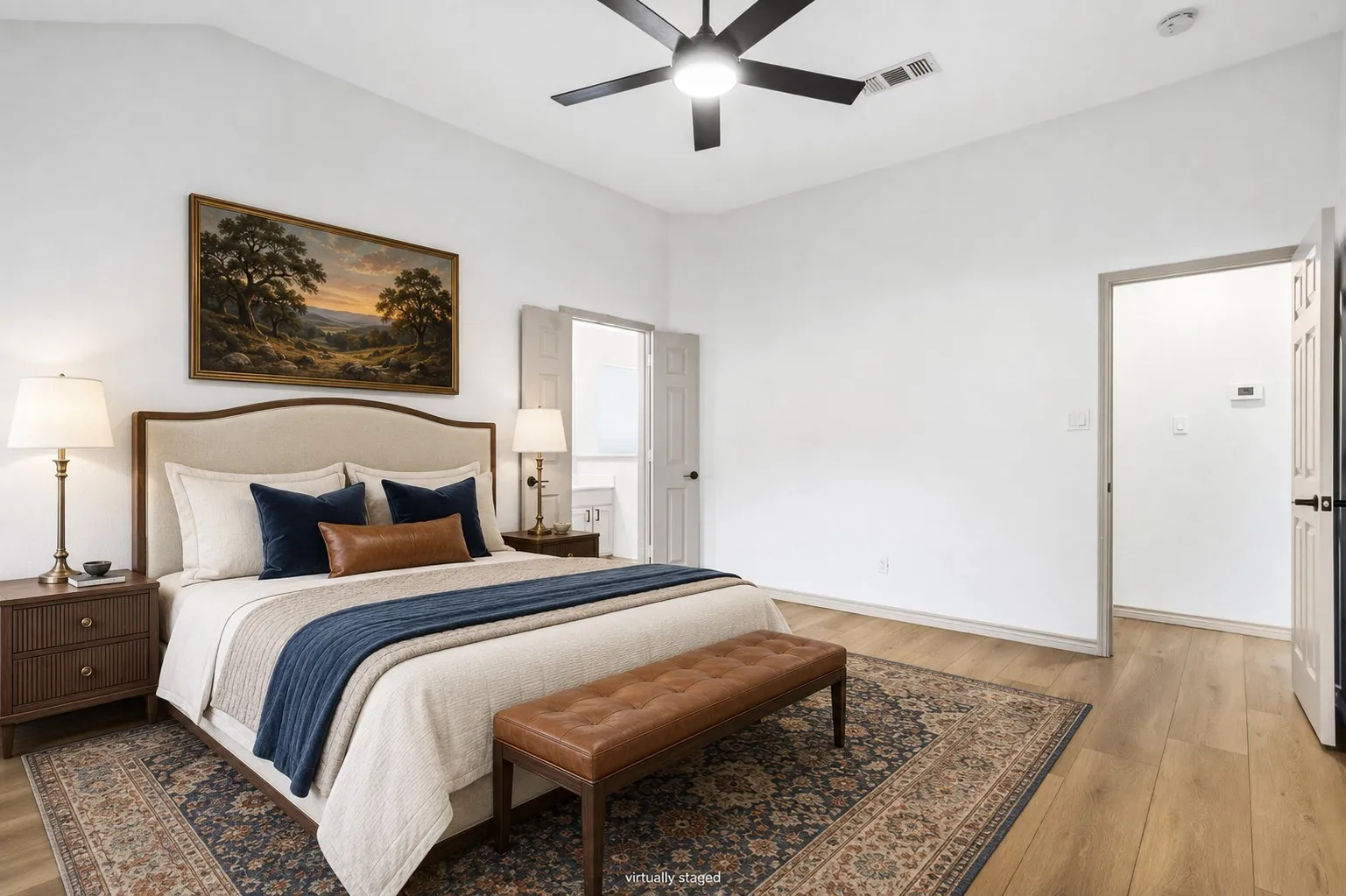 This primary bedroom offers high ceilings, beautiful floors, a great bathroom, and walk-in closet