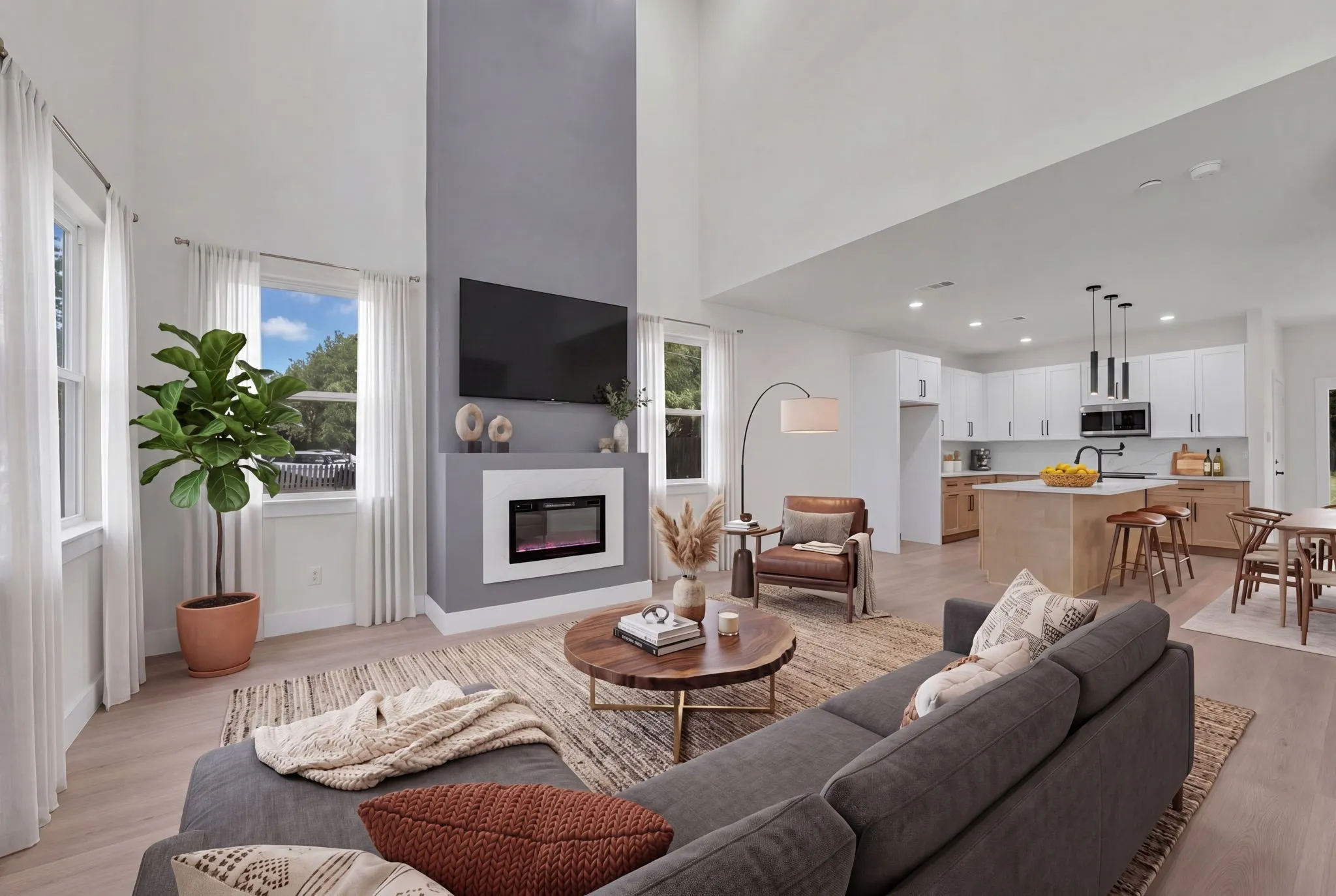 Vaulted living room featuring a floor-to-ceiling accent wall with a built-in electric fireplace
