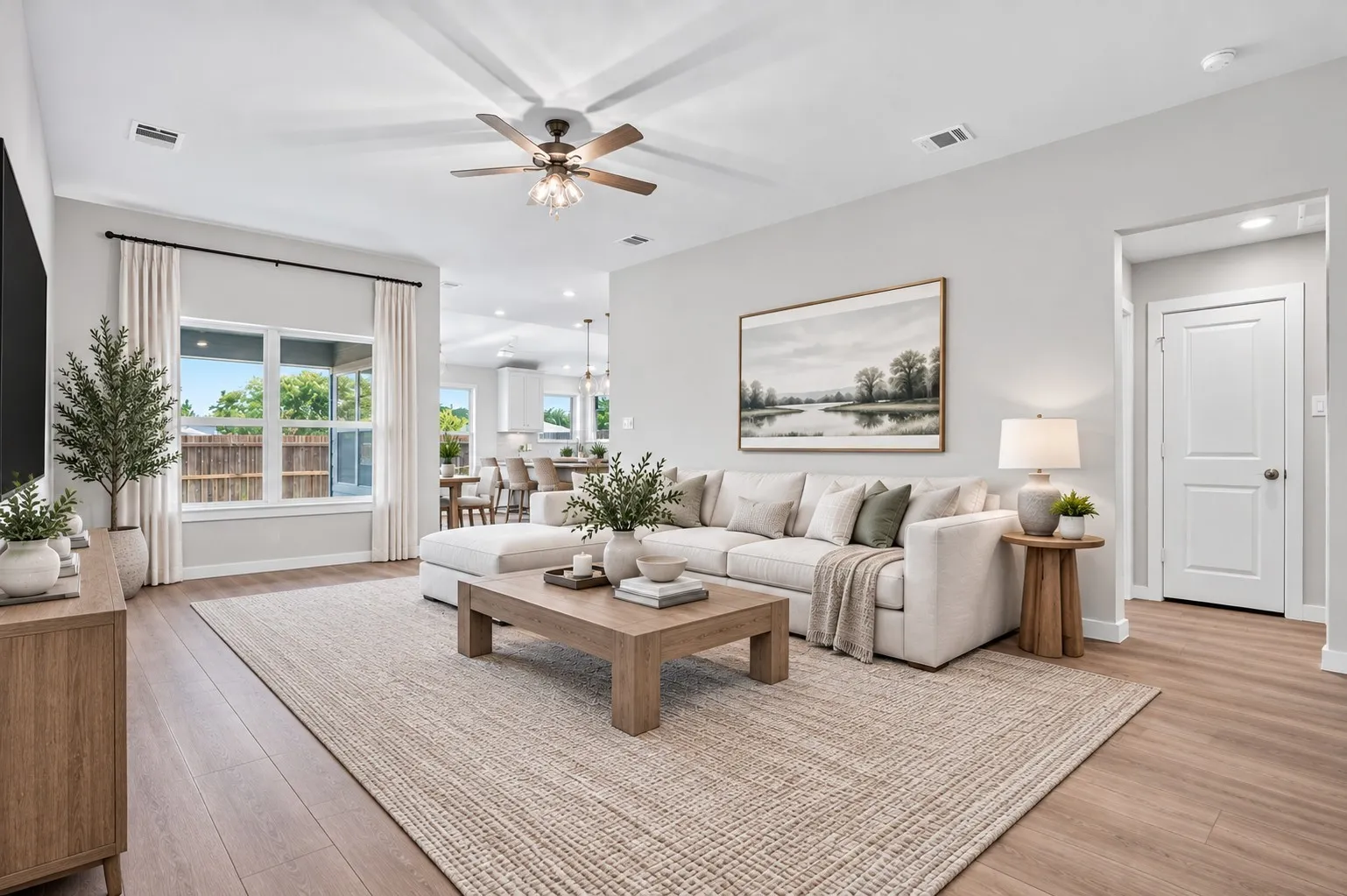 Open-concept living space featuring wood-finish flooring, recessed lighting, and a ceiling fan