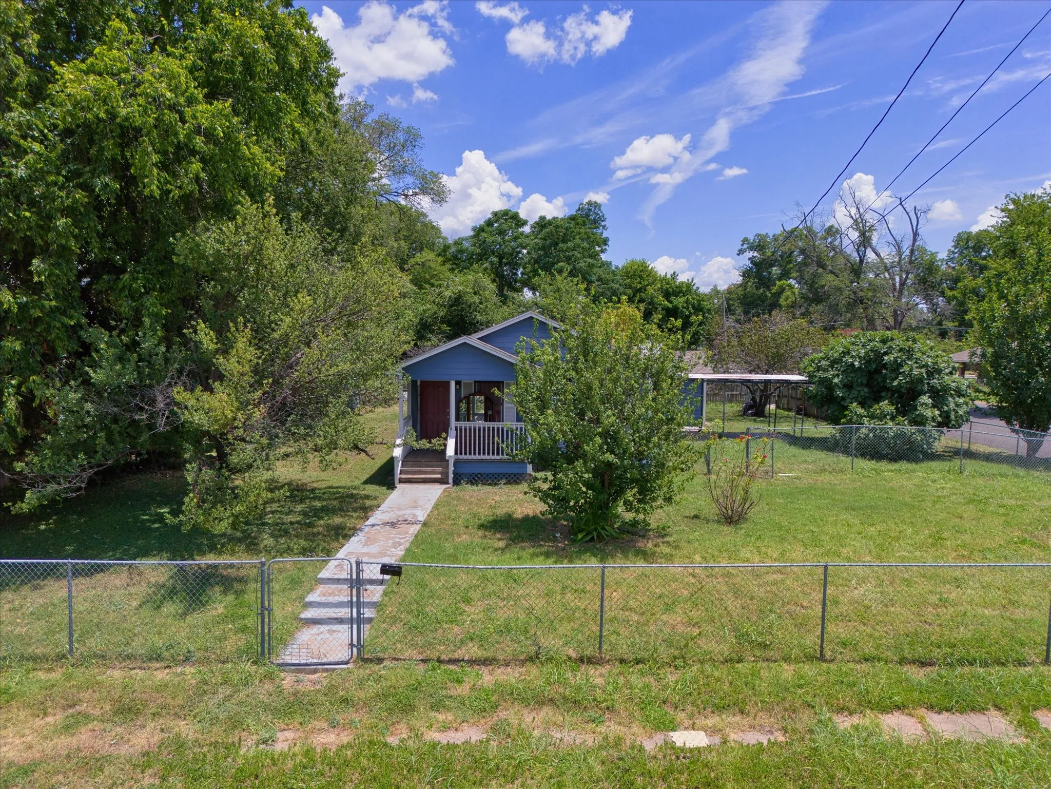 Blue siding exterior with a covered front porch featuring white railings