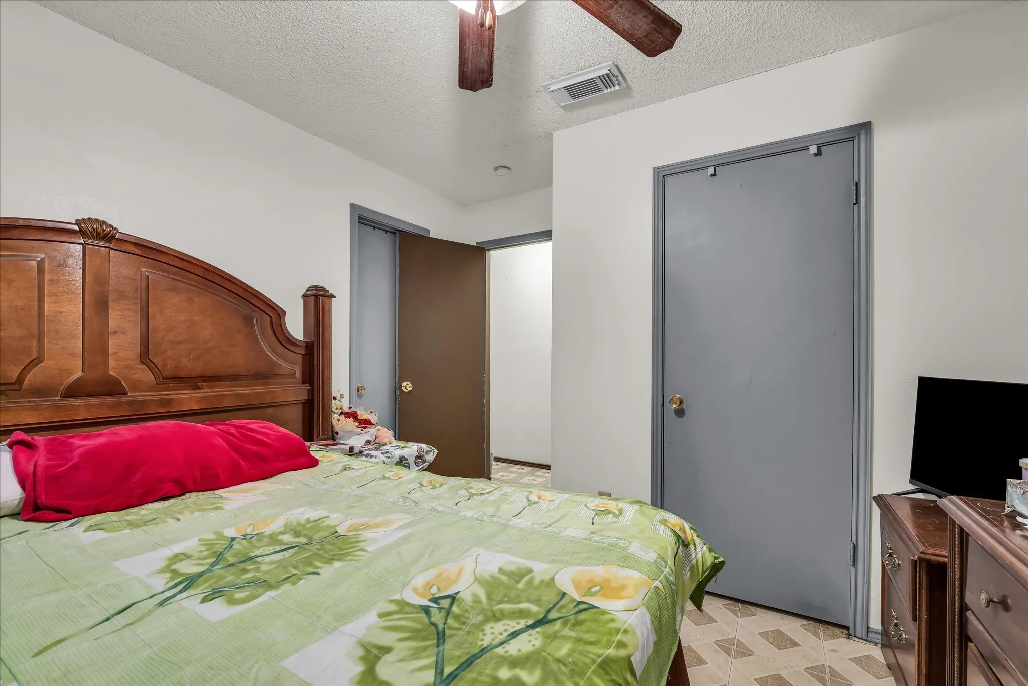 Interior room featuring neutral wall paint and patterned tile flooring