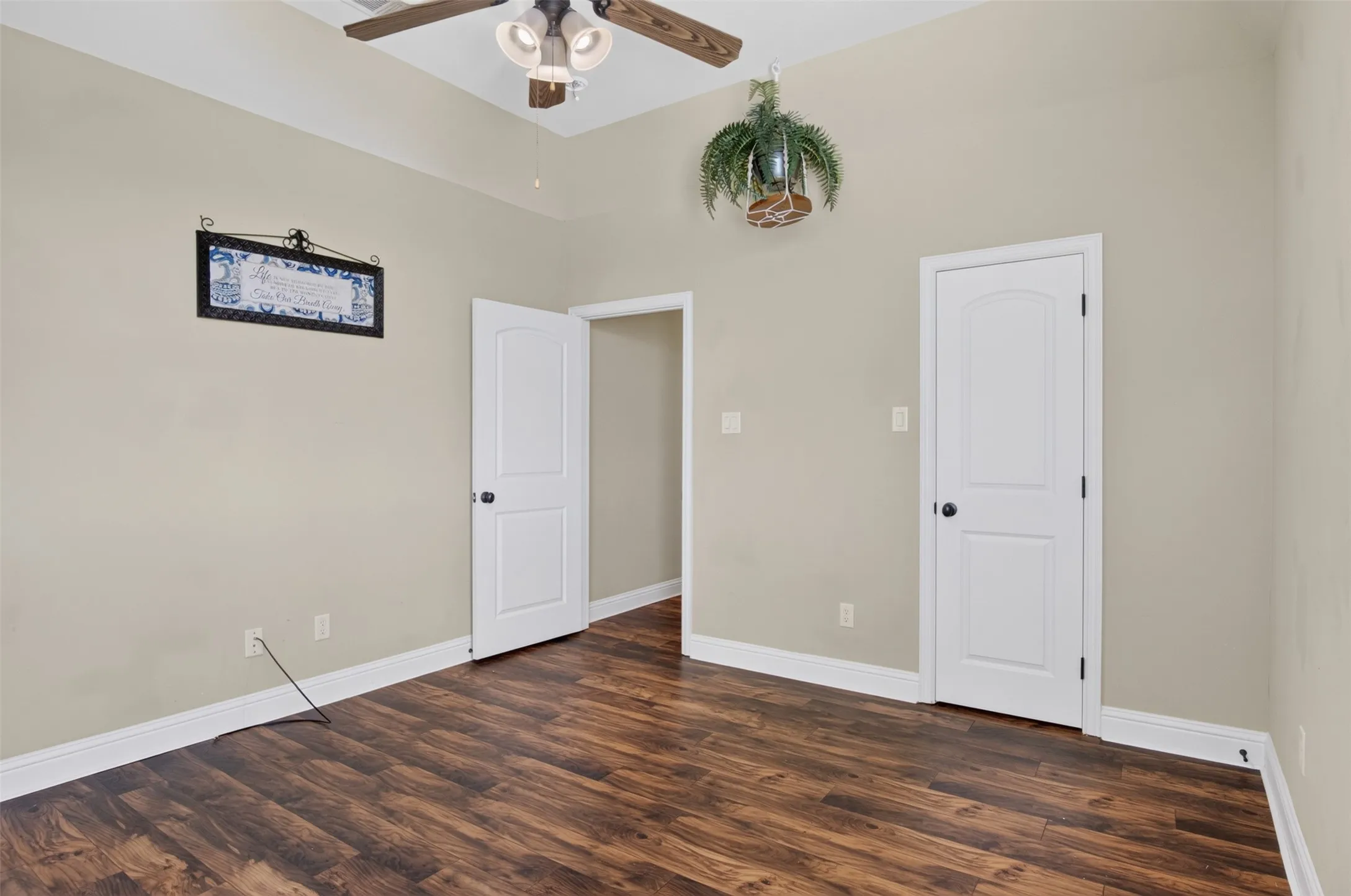 Secondary bedroom with ceiling fan and large closet